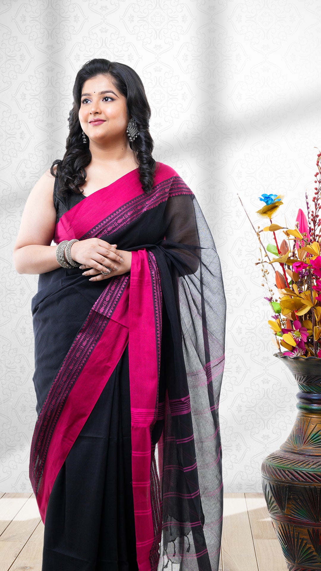 A soft cotton Tangail saree. A black base Tangail saree in soft cotton. The pallu is handwoven with stripes. Crafted with soft cotton Warp and weft. Standard 5.5-meter length.