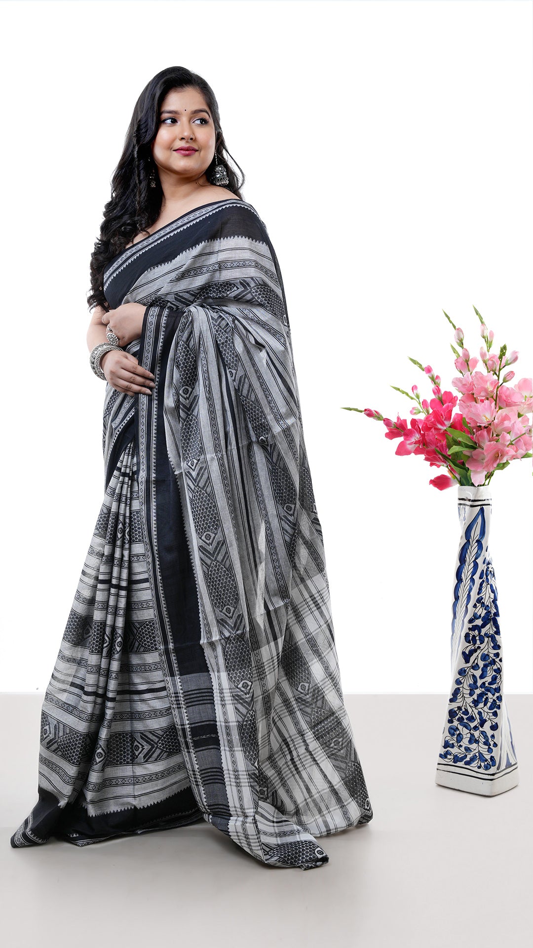 A black dhanekhali saree. A black coloured sari with subtle red weave. Crafted with cotton Warp and weft. Standard 5.5-meter length. Includes matching blouse piece. cotton saree