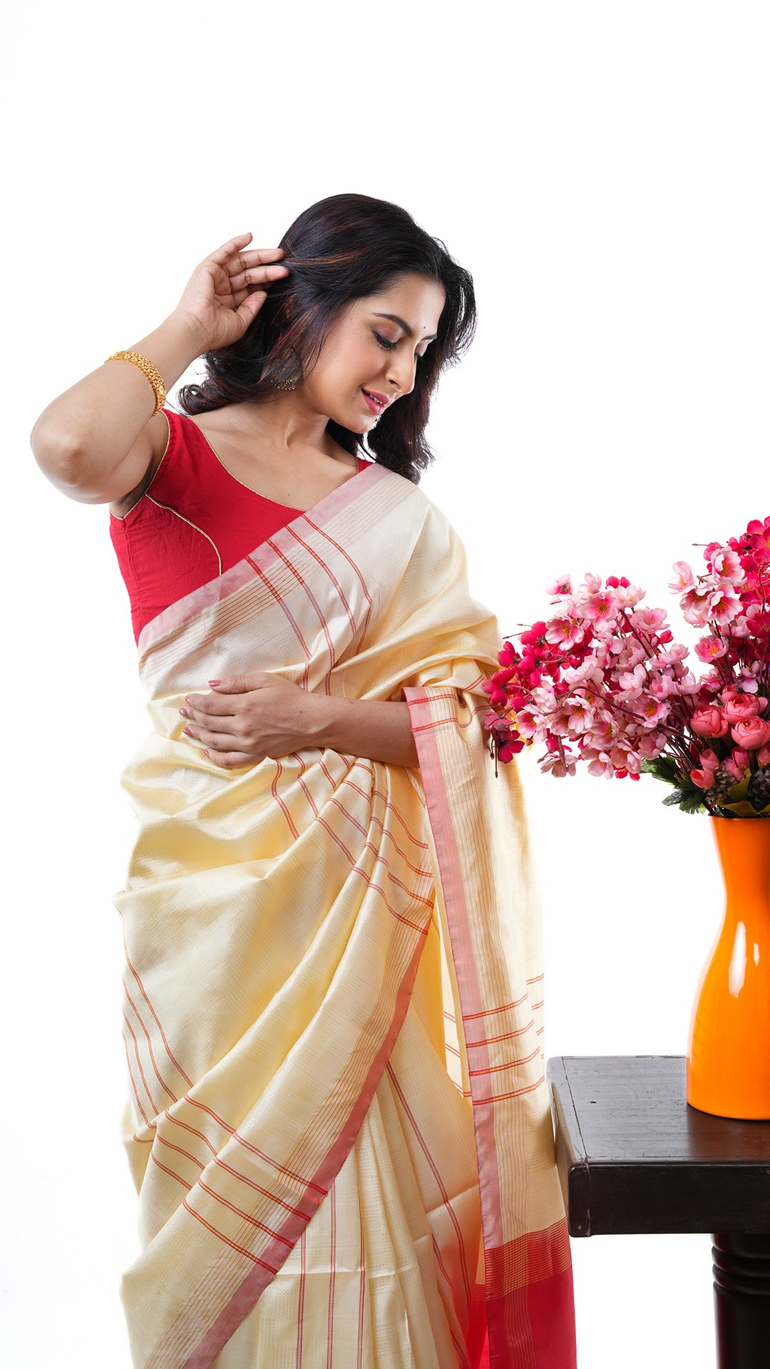 An off white red silk saree