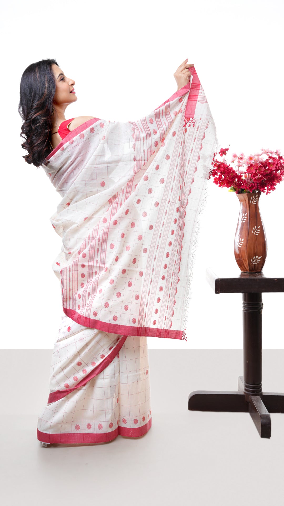 An off white red cotton saree
