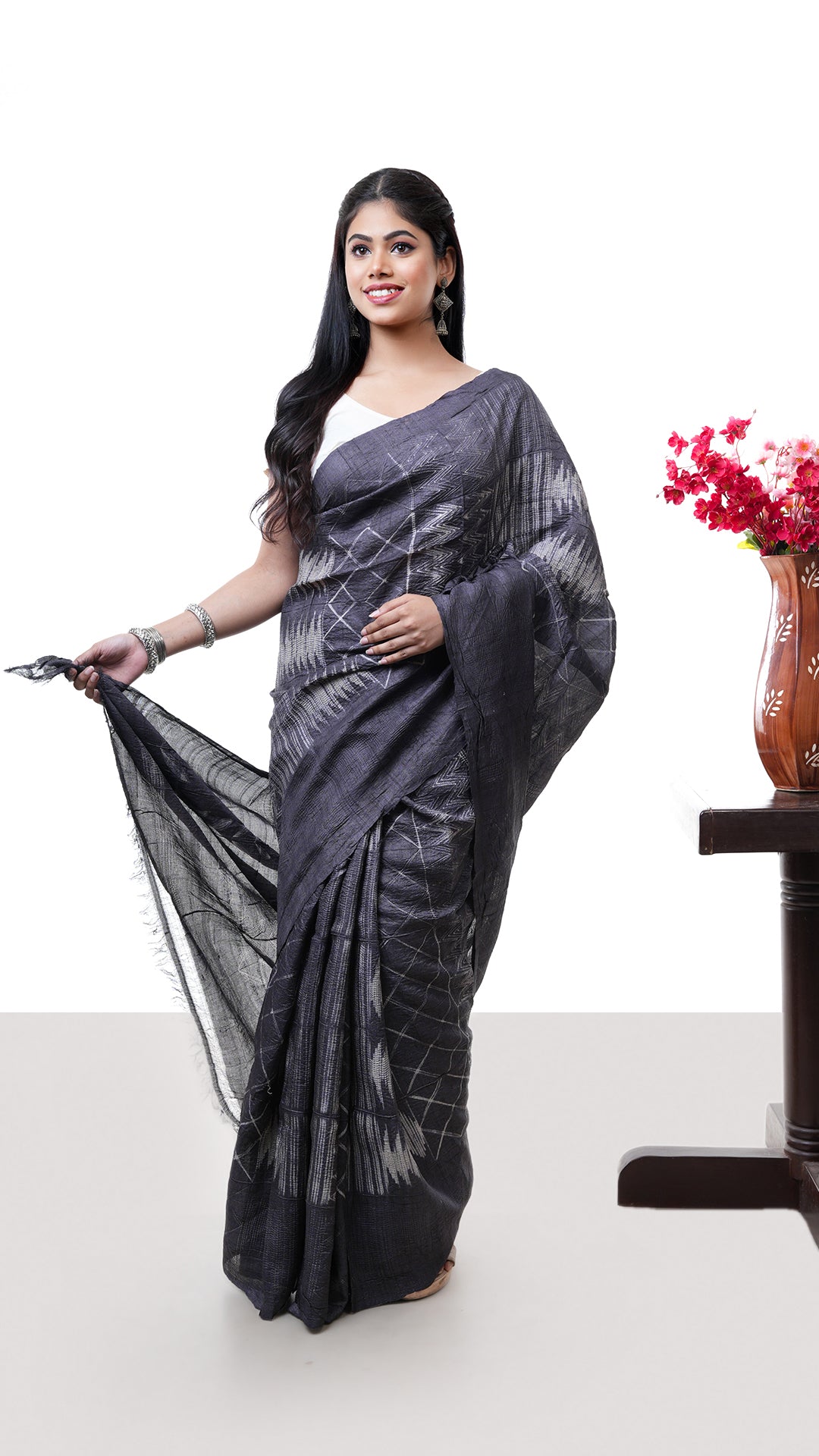 A charcoal coloured shibori. A tassar shibori sari with subtle tie-dye effect. Crafted with tassar Warp and weft. Standard 5.5-meter length. Includes matching blouse piece. tassar, handloom silk sari