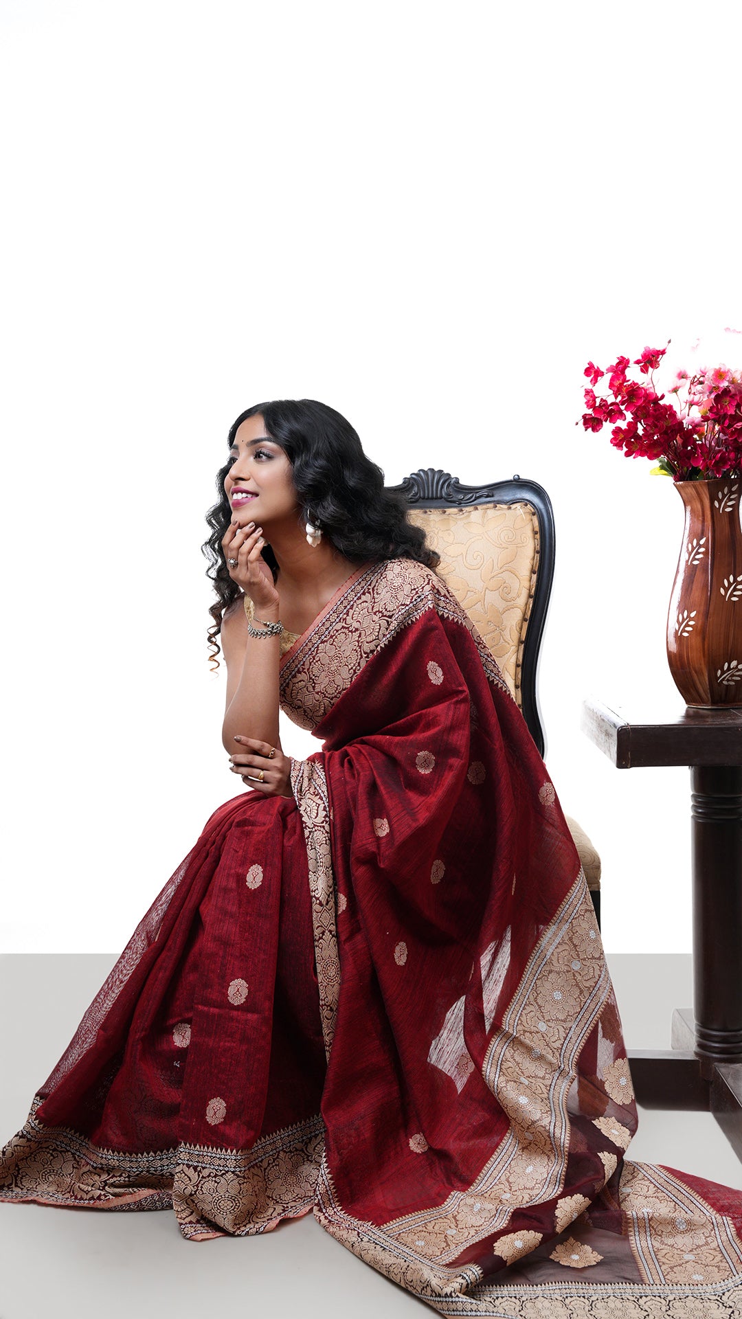 A raw silk saree in maroon colour