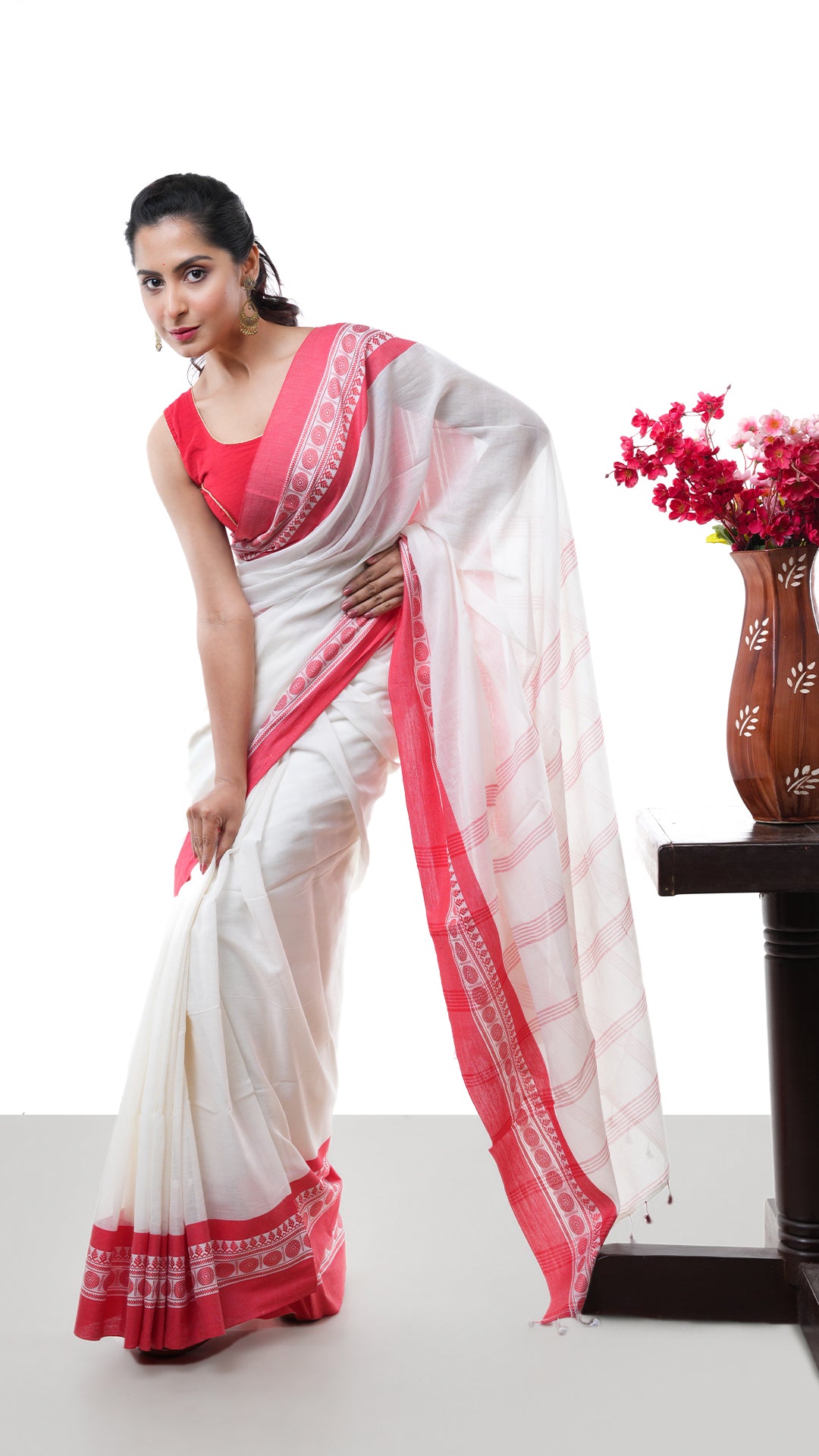 An off white and red tangail saree
