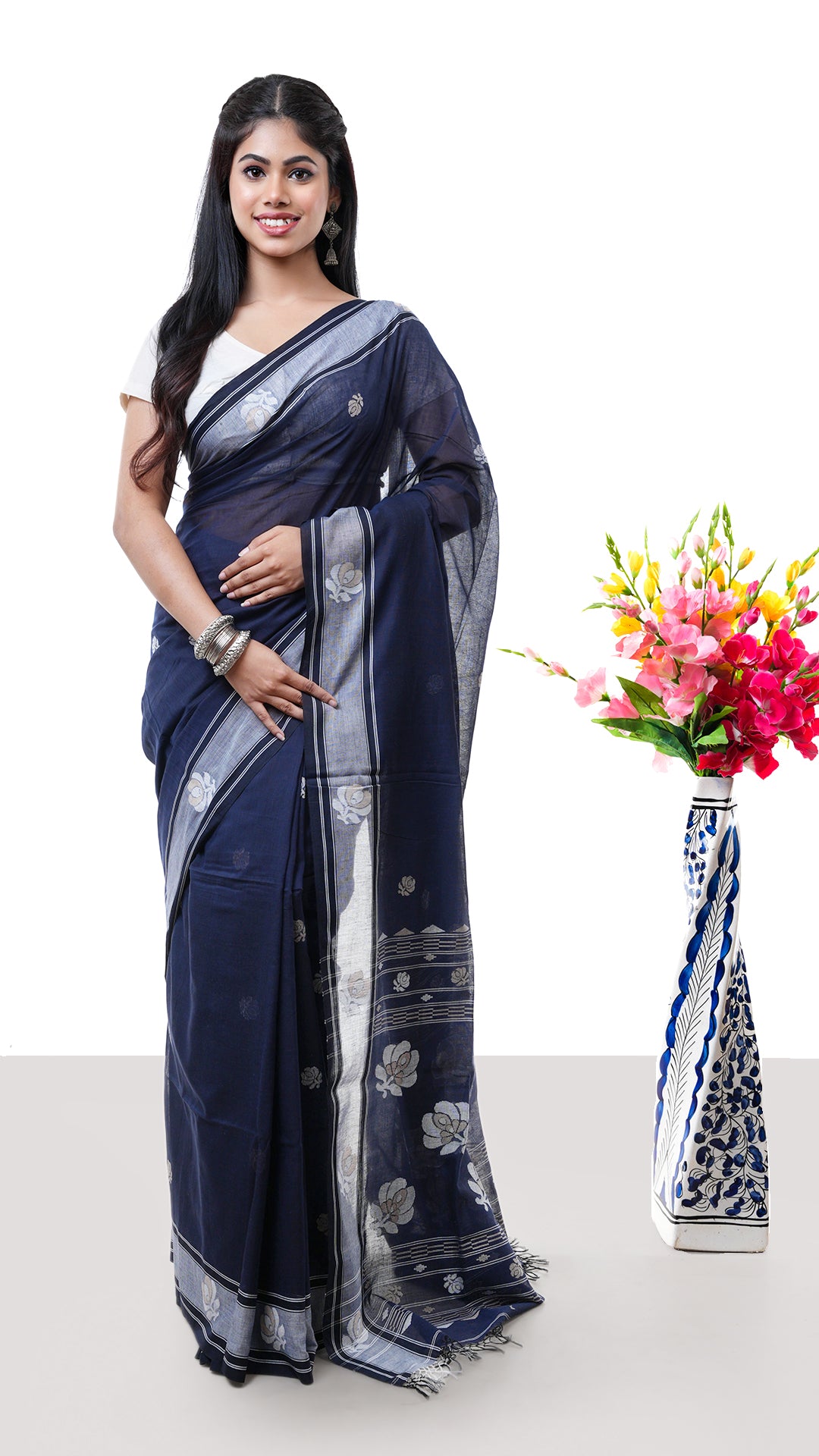 A midnight blue Tangail saree. A Tangail saree in deep blue shade with contrast border. Crafted with soft cotton Warp and weft. Standard 5.5-meter length. Includes matching blouse piece. Tangail saree, cotton saree