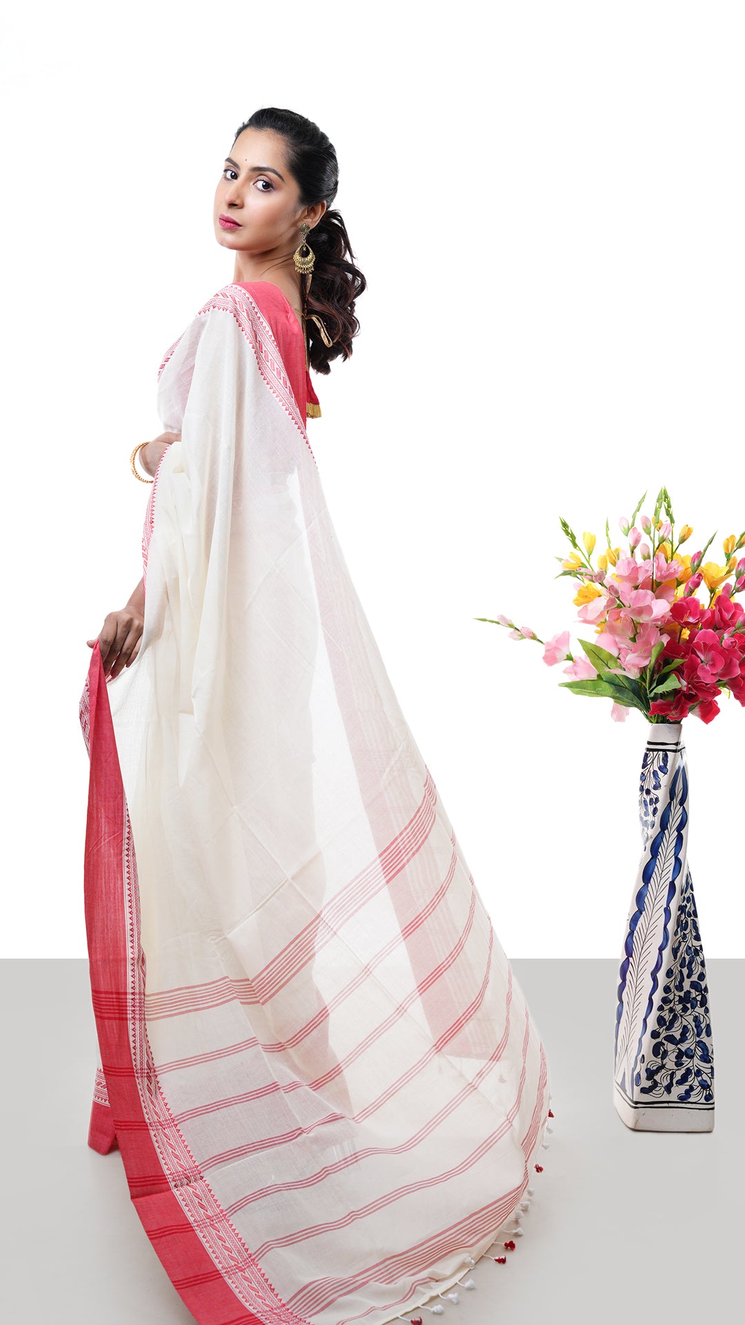 An off white and red tangail saree