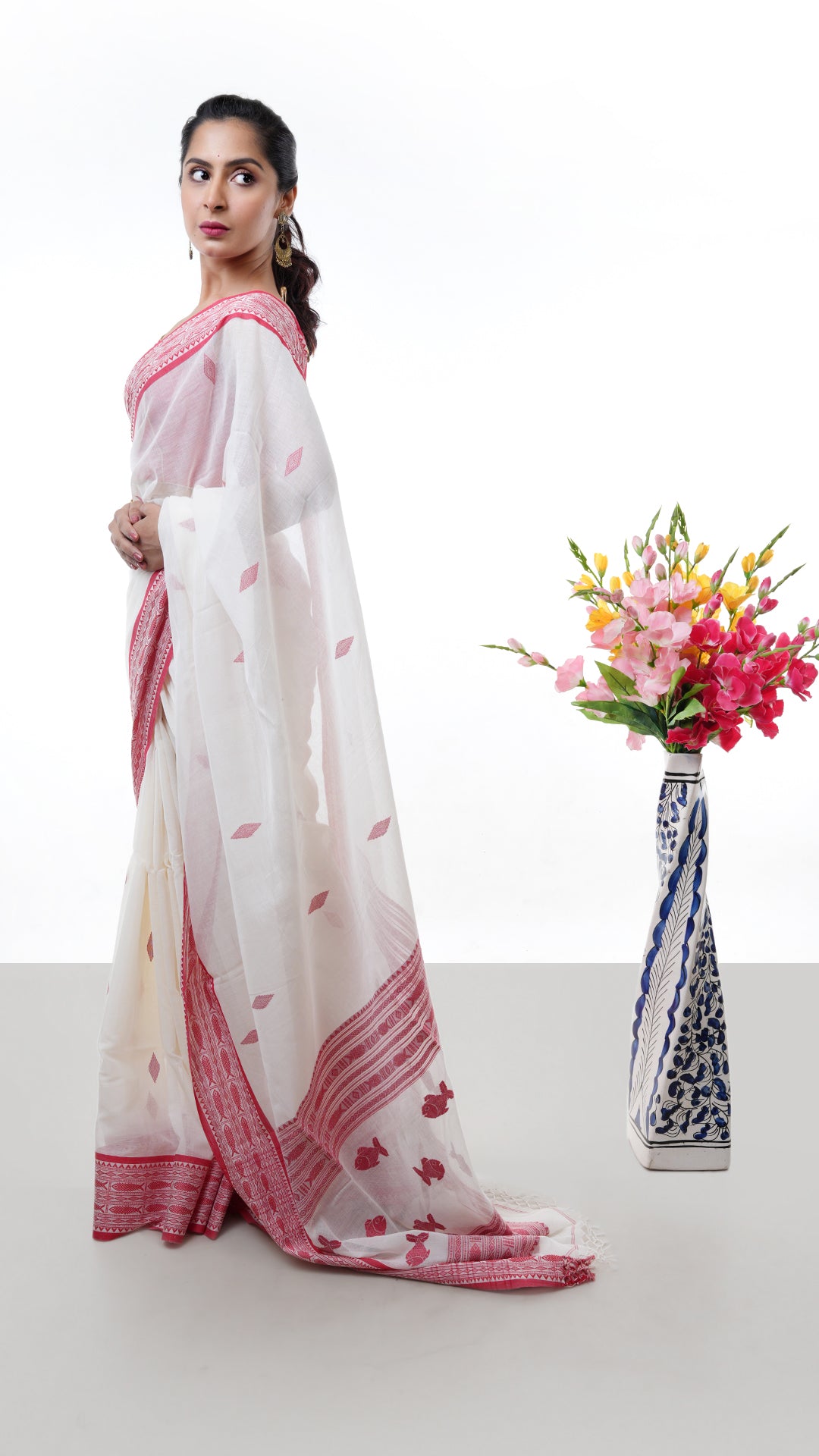 An off white and red tangail saree