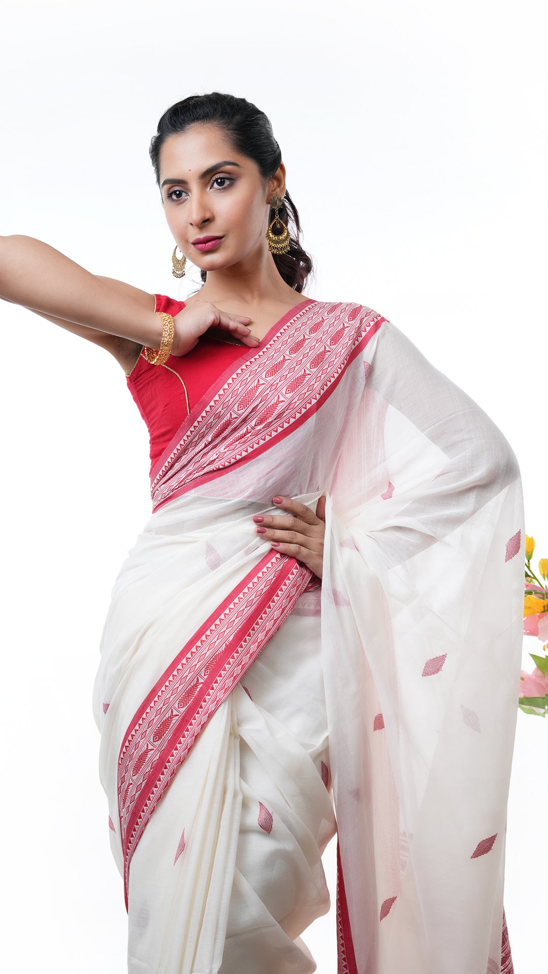 An off white and red tangail saree