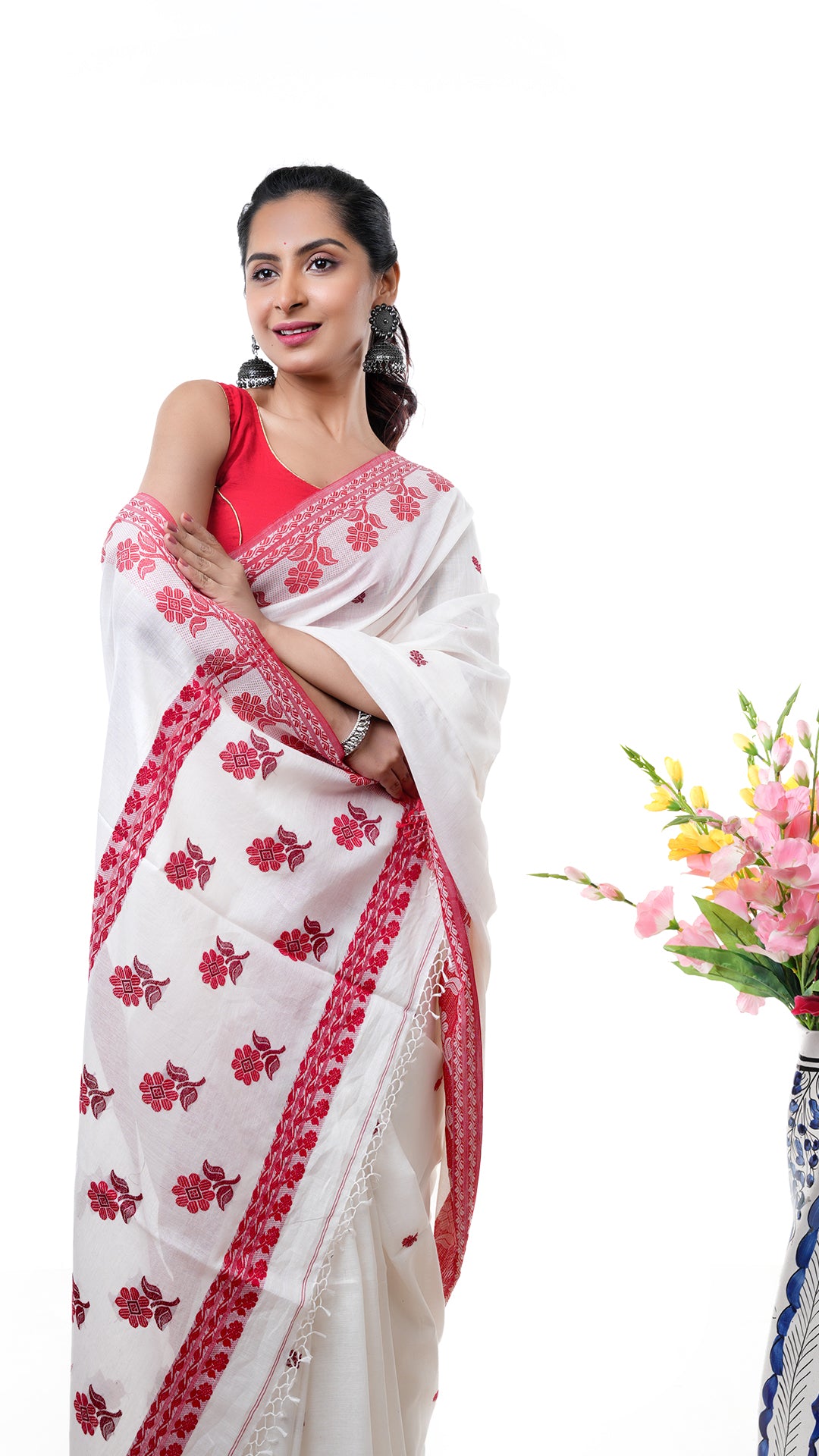 An off white and red tangail saree