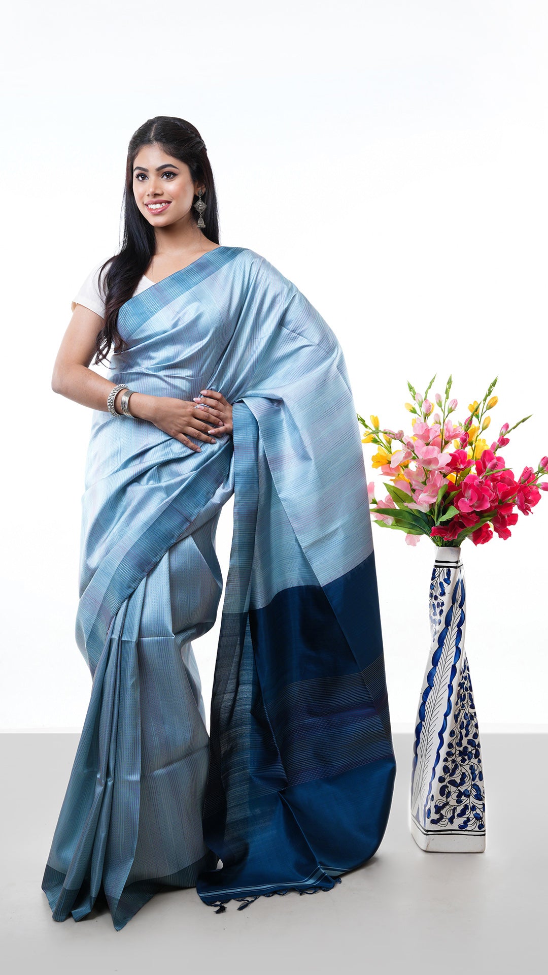 A light blue silk saree. A light blue coloured silk saree with rich sheen. Crafted with silk Warp and weft. Standard 5.5-meter length. Includes matching blouse piece. handloom silk sari