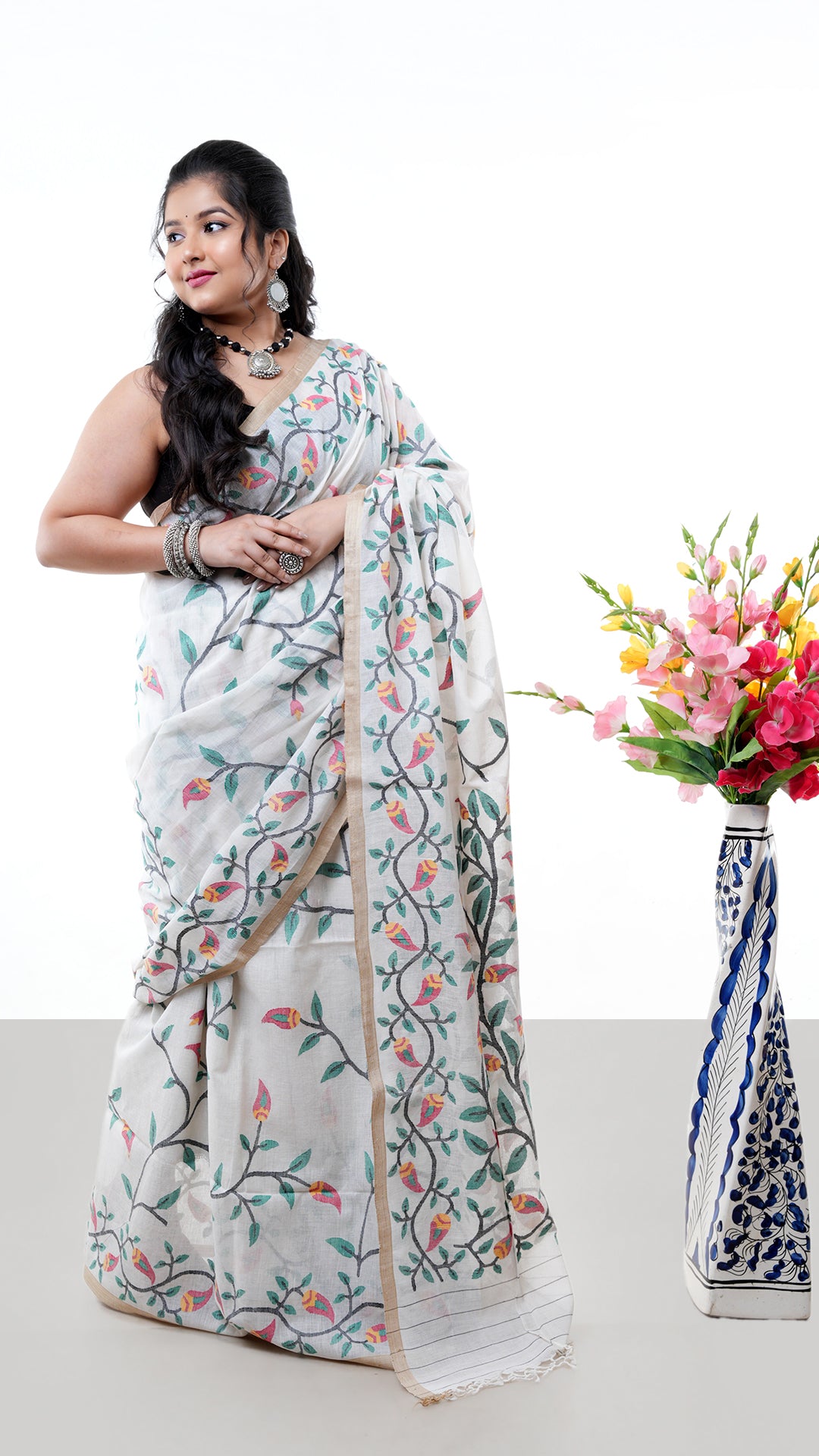A multi coloured off white saree. An off white base sari with multicolor accents on pallu and border. Crafted with soft cotton Warp and weft. Standard 5.5-meter length. Includes matching blouse piece. cotton saree