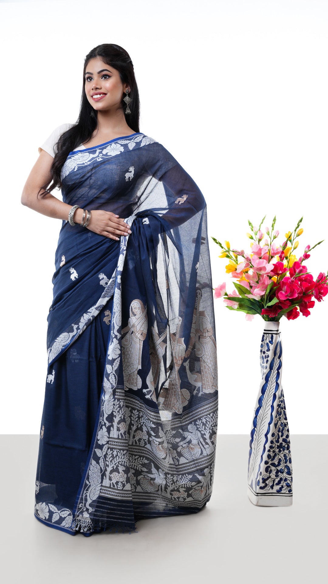 A deep blue baluchari saree. A soft cotton sari with elaborate pallu design. Crafted with soft cotton Warp and weft. Standard 5.5-meter length. Includes matching blouse piece. cotton saree