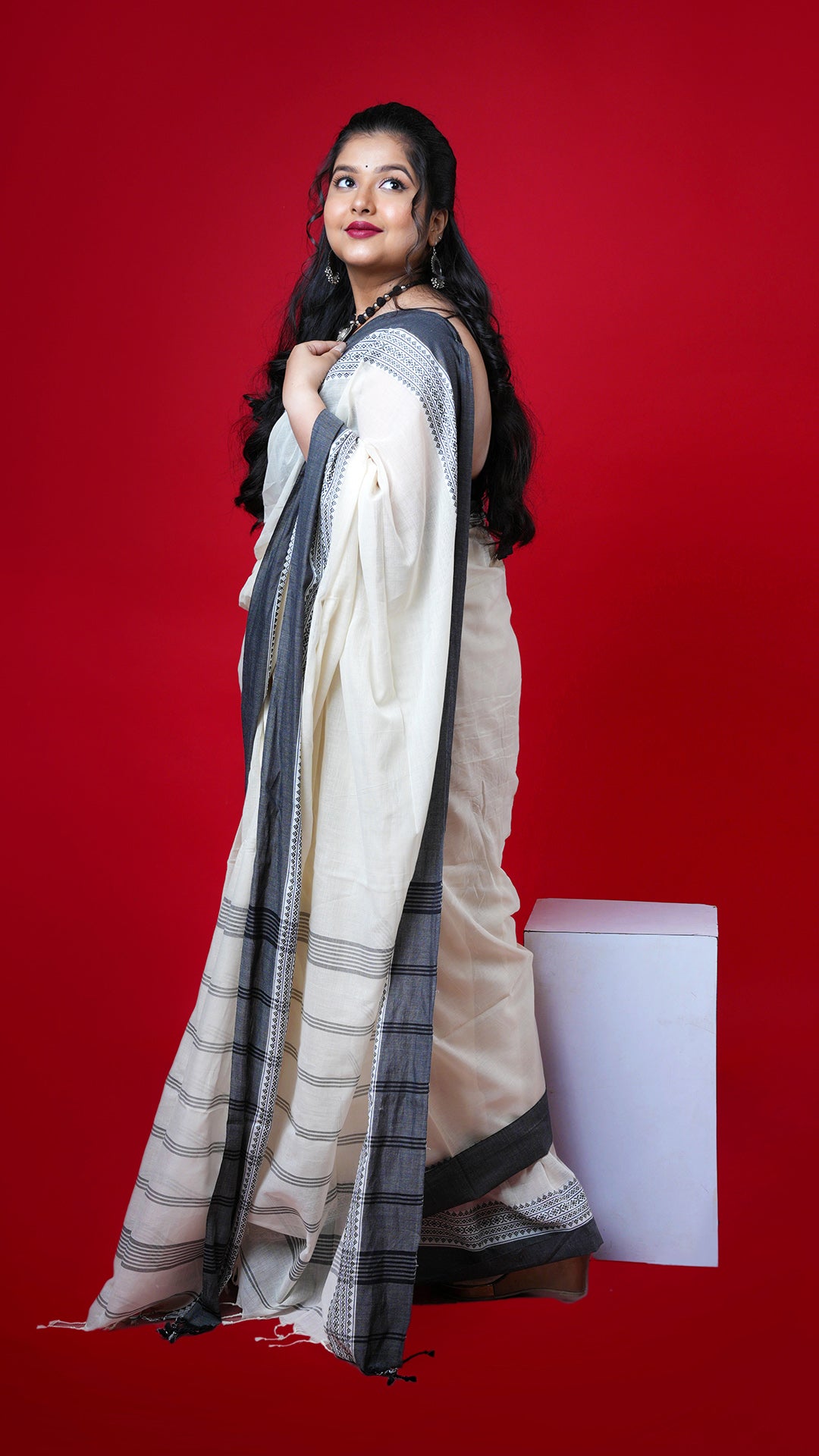 An off white and black tangail saree