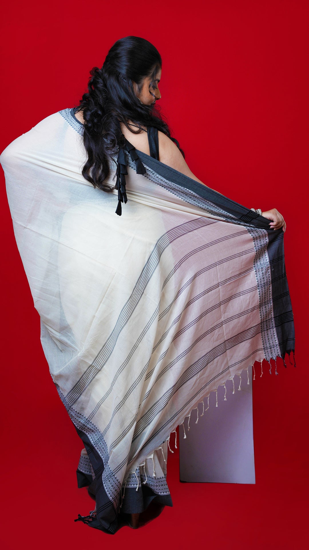 An off white and black tangail saree