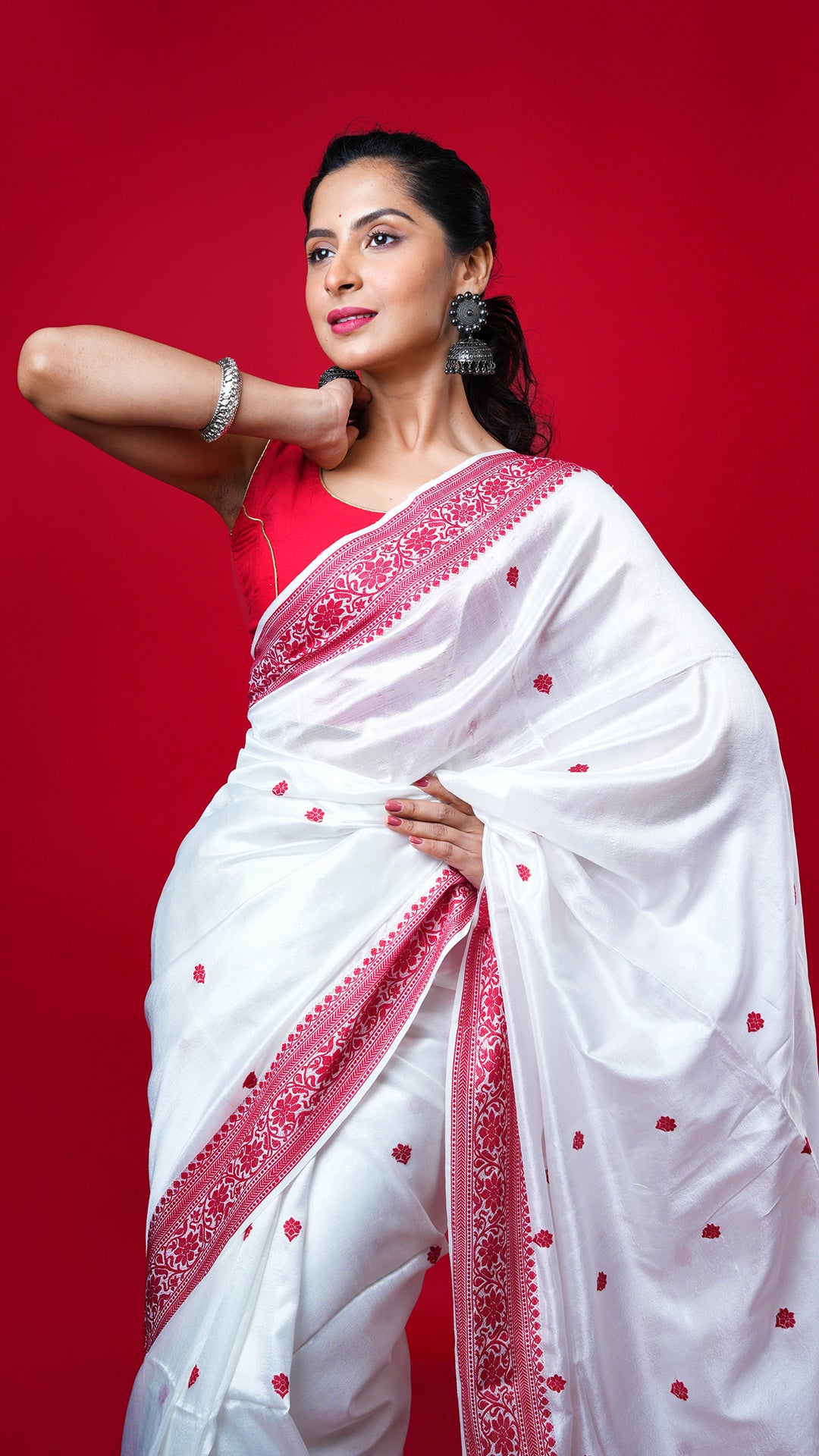 An off white and red silk saree. A tangail silk saree in subtle off-white with bright red border. Crafted with silk Warp and weft. Standard 5.5-meter length. Includes matching blouse piece. Tangail saree, handloom silk sari
