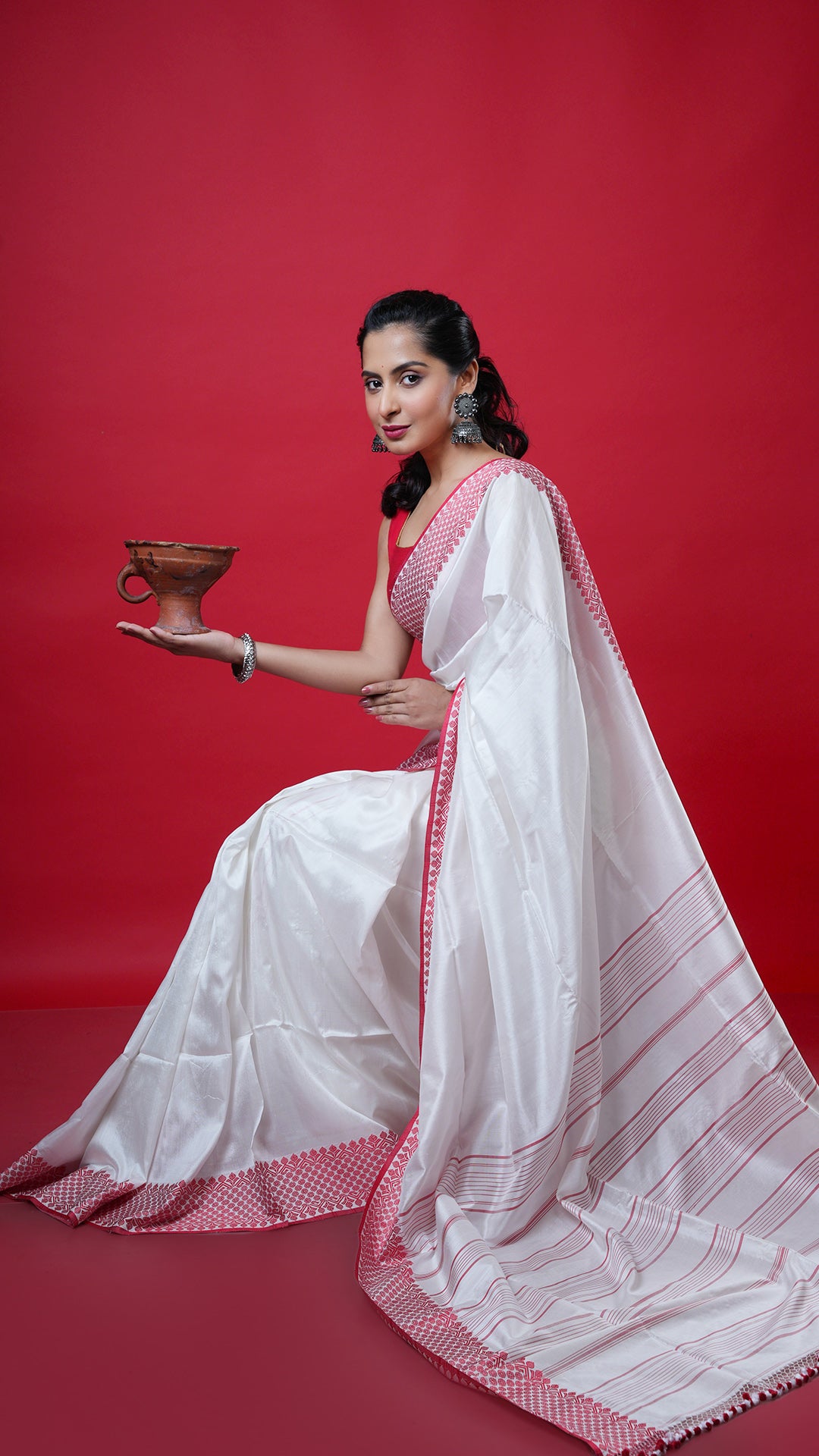 An off white with red silk saree