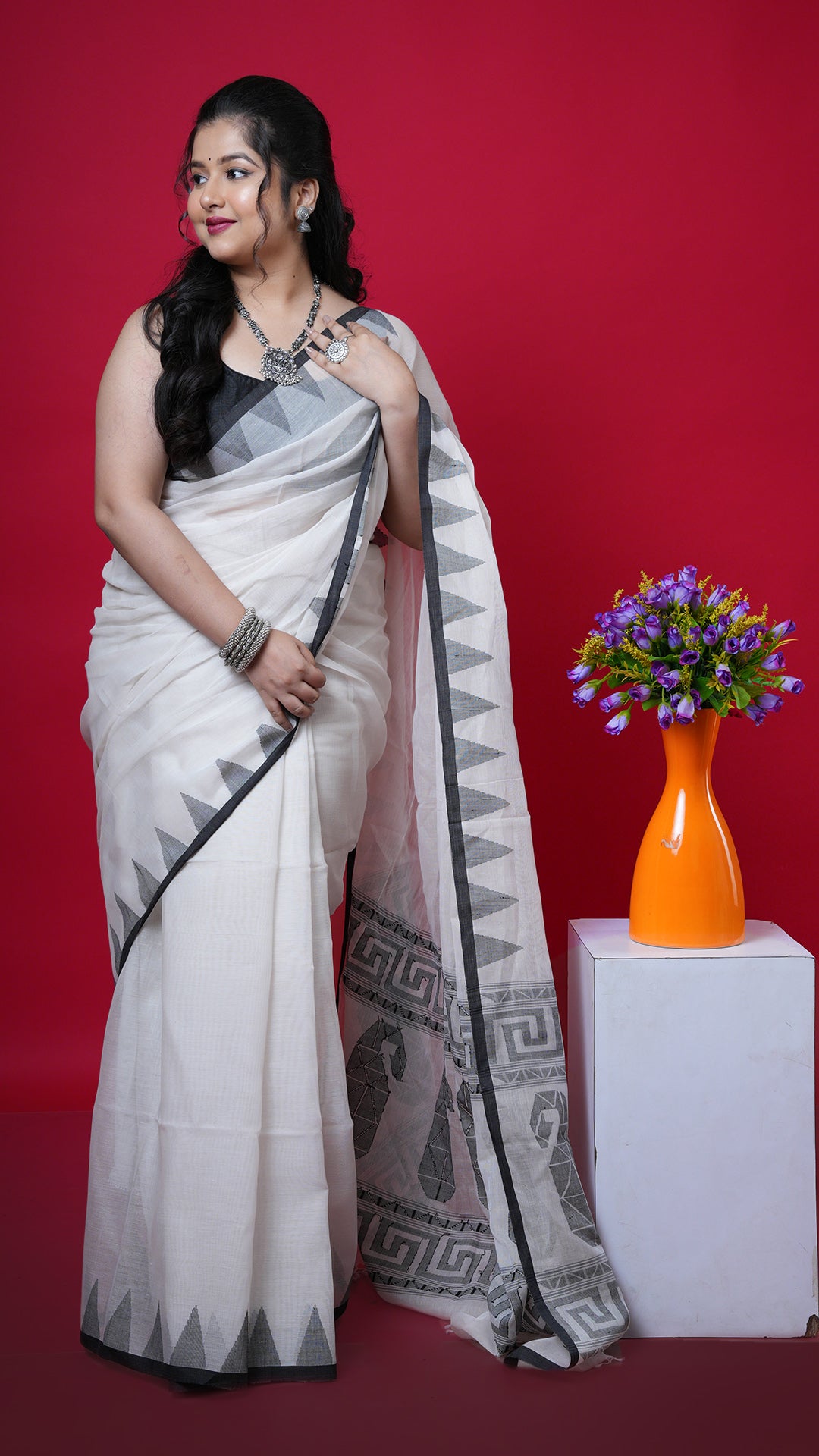 An off white and black dhakai saree