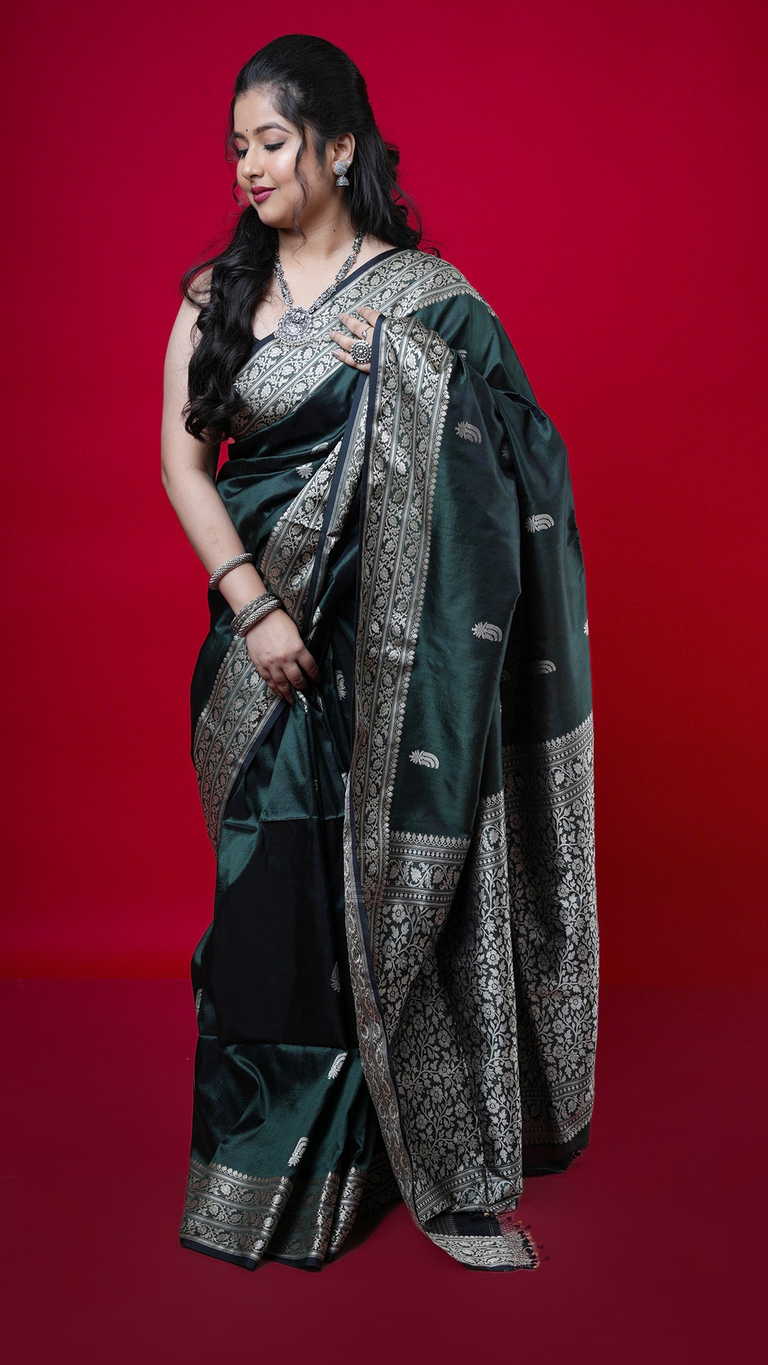 A bottle green coloured silk saree