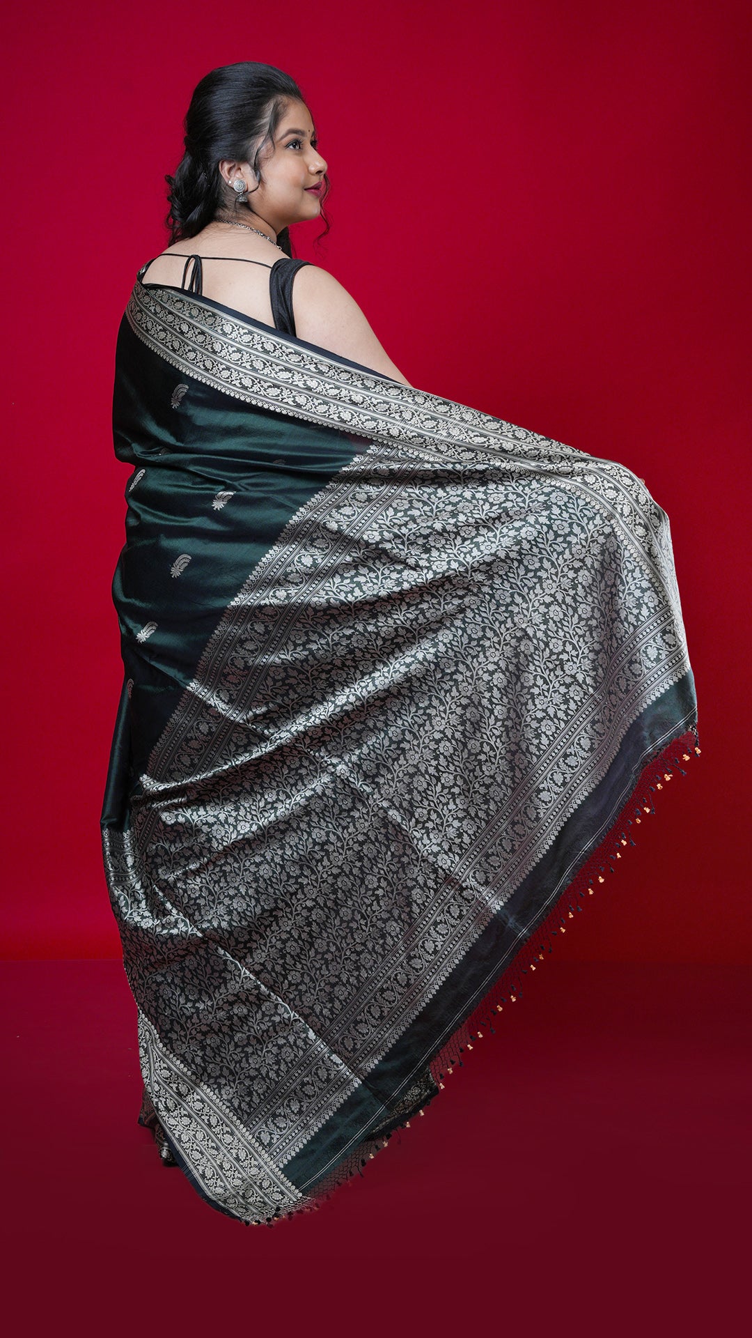 A bottle green coloured silk saree