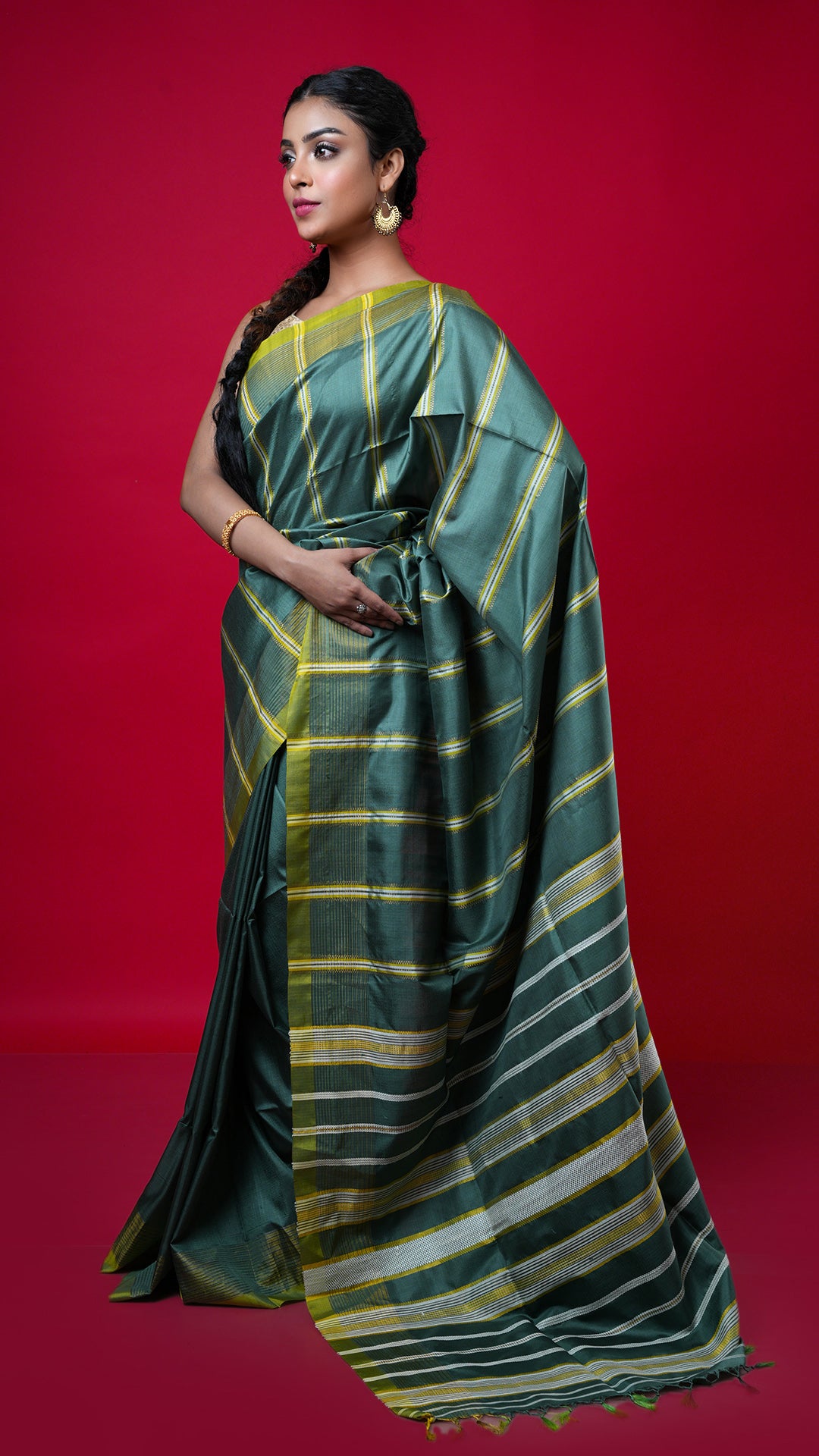 A green coloured silk saree. The border and pallu enhance the green tone. Crafted with silk Warp and weft. Standard 5.5-meter length. Includes matching blouse piece. handloom silk sari