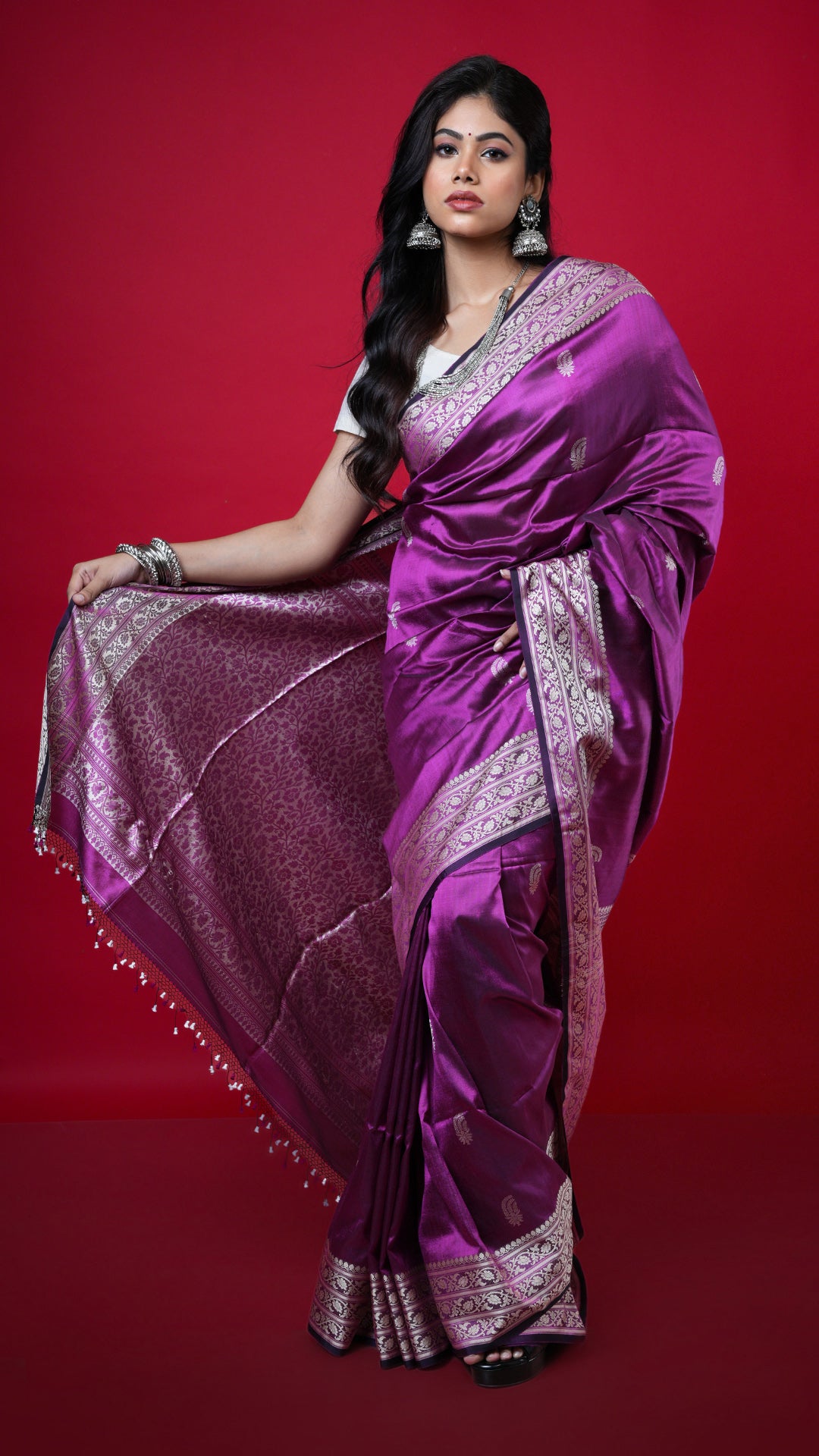 A magenta coloured silk saree. A magenta toned silk saree with soft finish. Crafted with silk Warp and weft. Standard 5.5-meter length. Includes matching blouse piece. handloom silk sari
