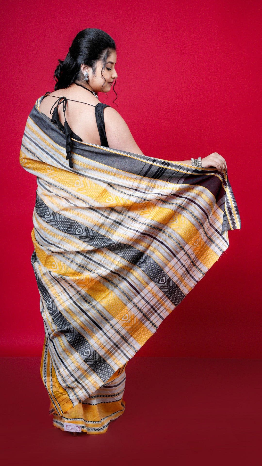 A black with yellow dhanekhali saree