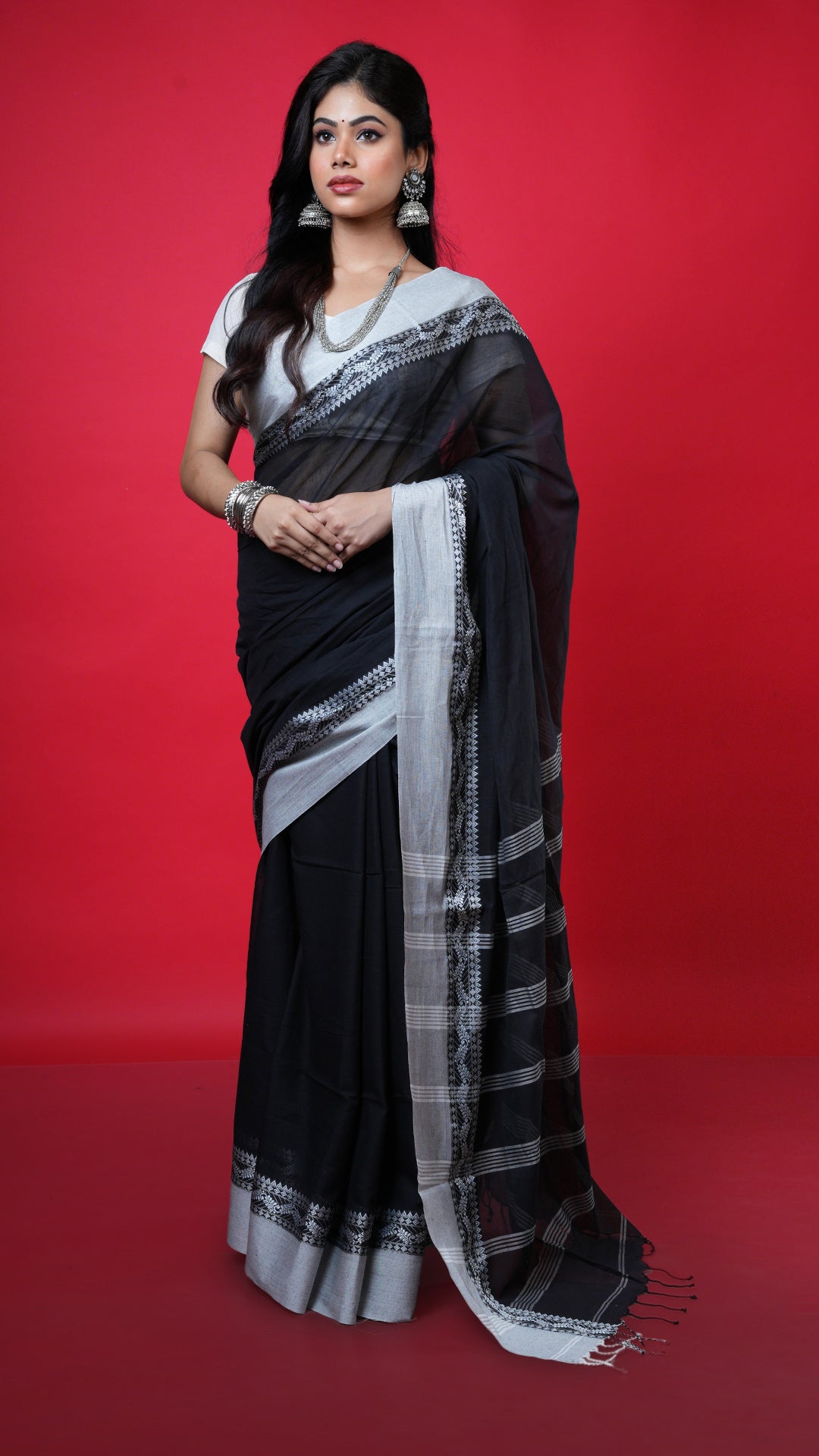 A black with white tangail saree