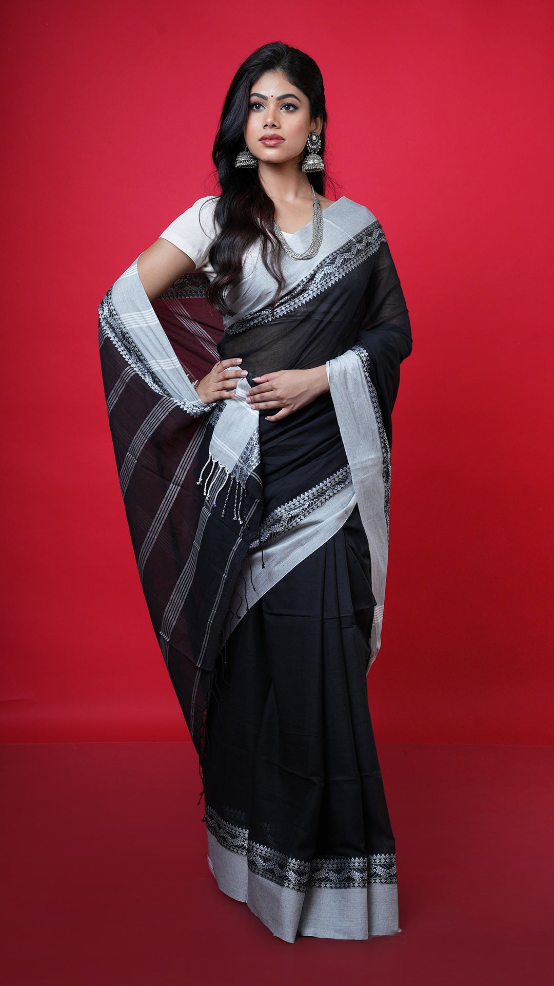 A black with white tangail saree. A soft cotton sari with reverse colour play. Crafted with soft cotton Warp and weft. Standard 5.5-meter length. Includes matching blouse piece. Tangail saree, cotton saree