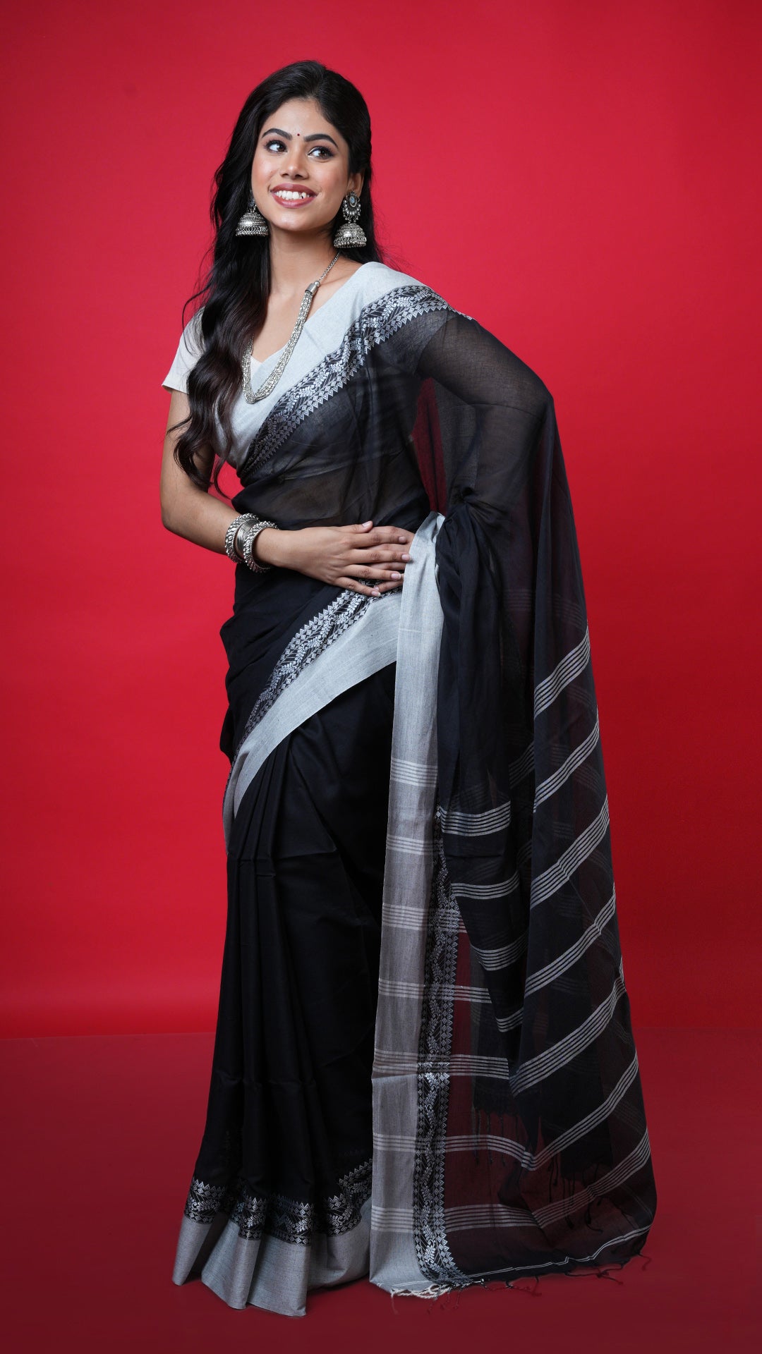 A black with white tangail saree