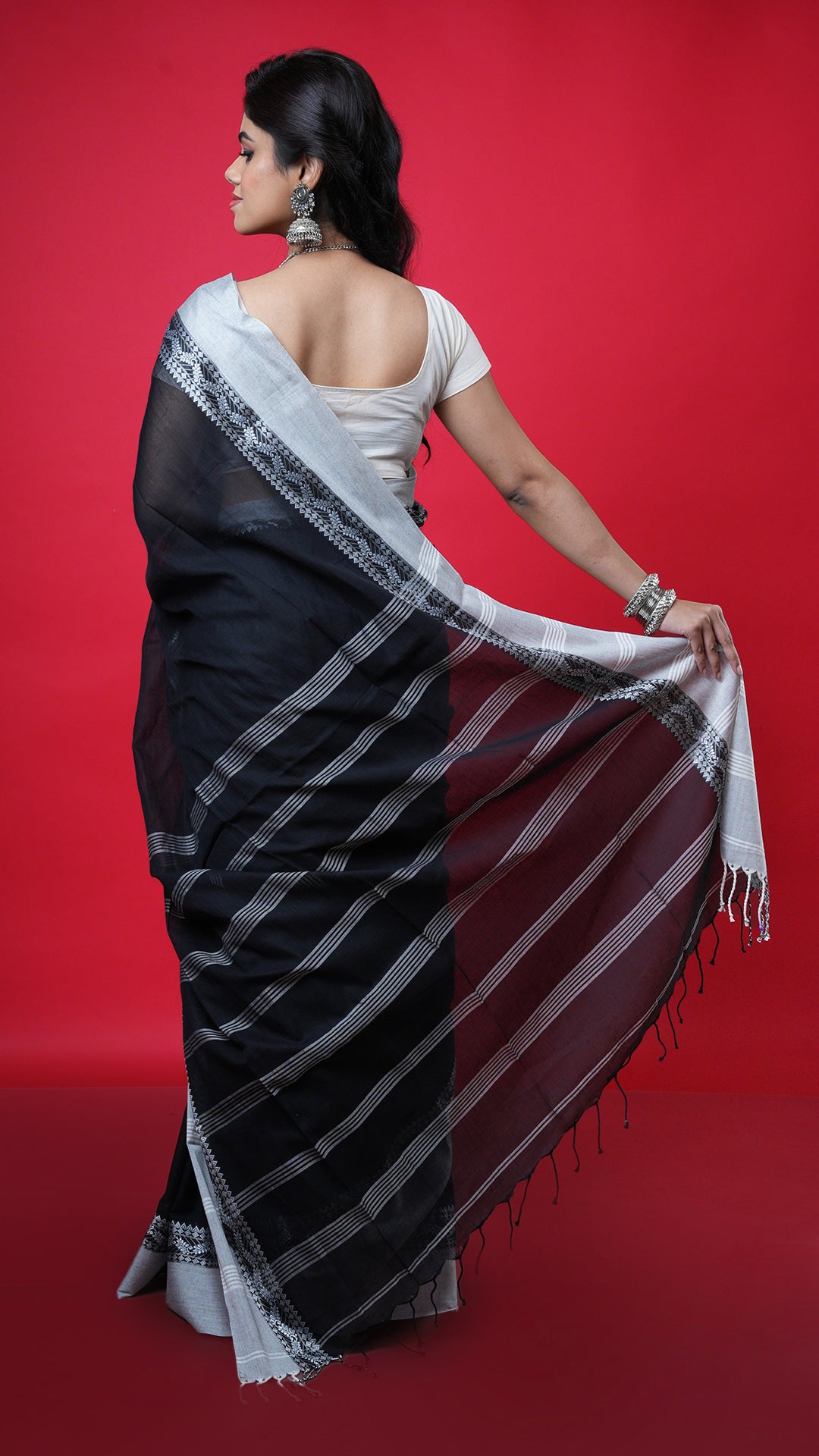 A black with white tangail saree
