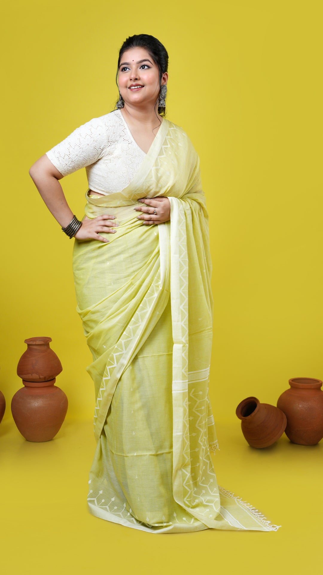 A yellowish green dhakai saree