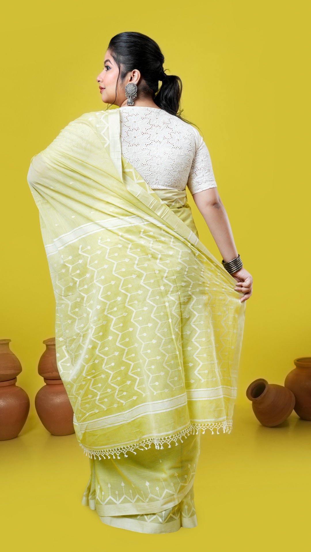 A yellowish green dhakai saree