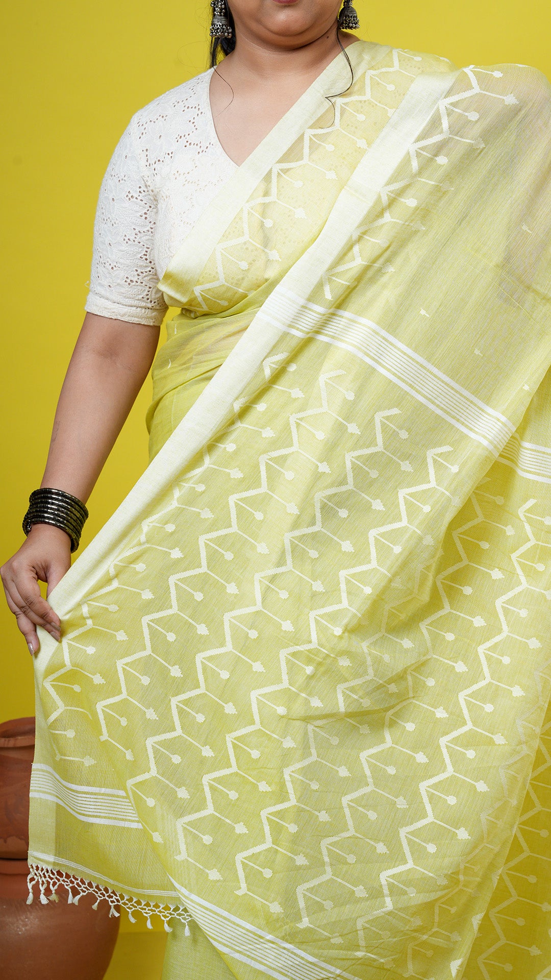 A yellowish green dhakai saree