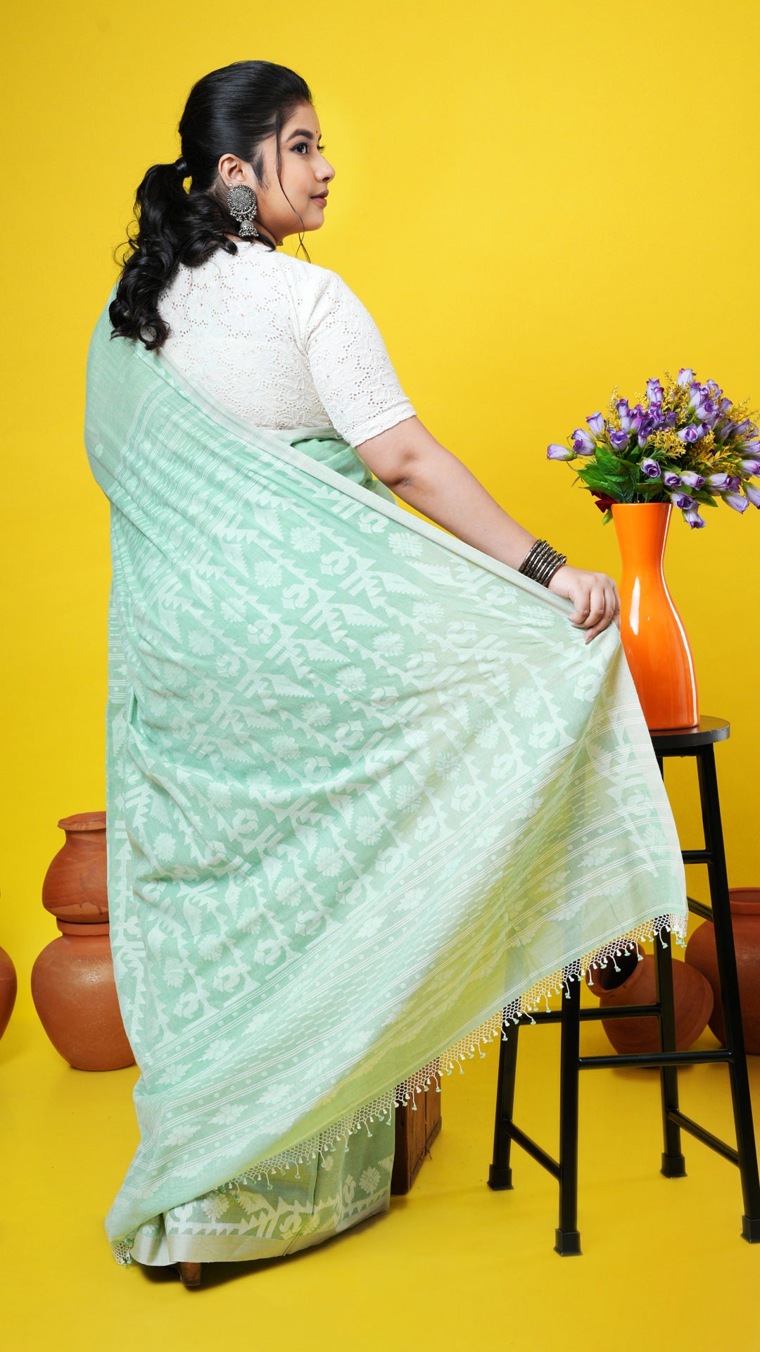 A light green coloured dhakai saree