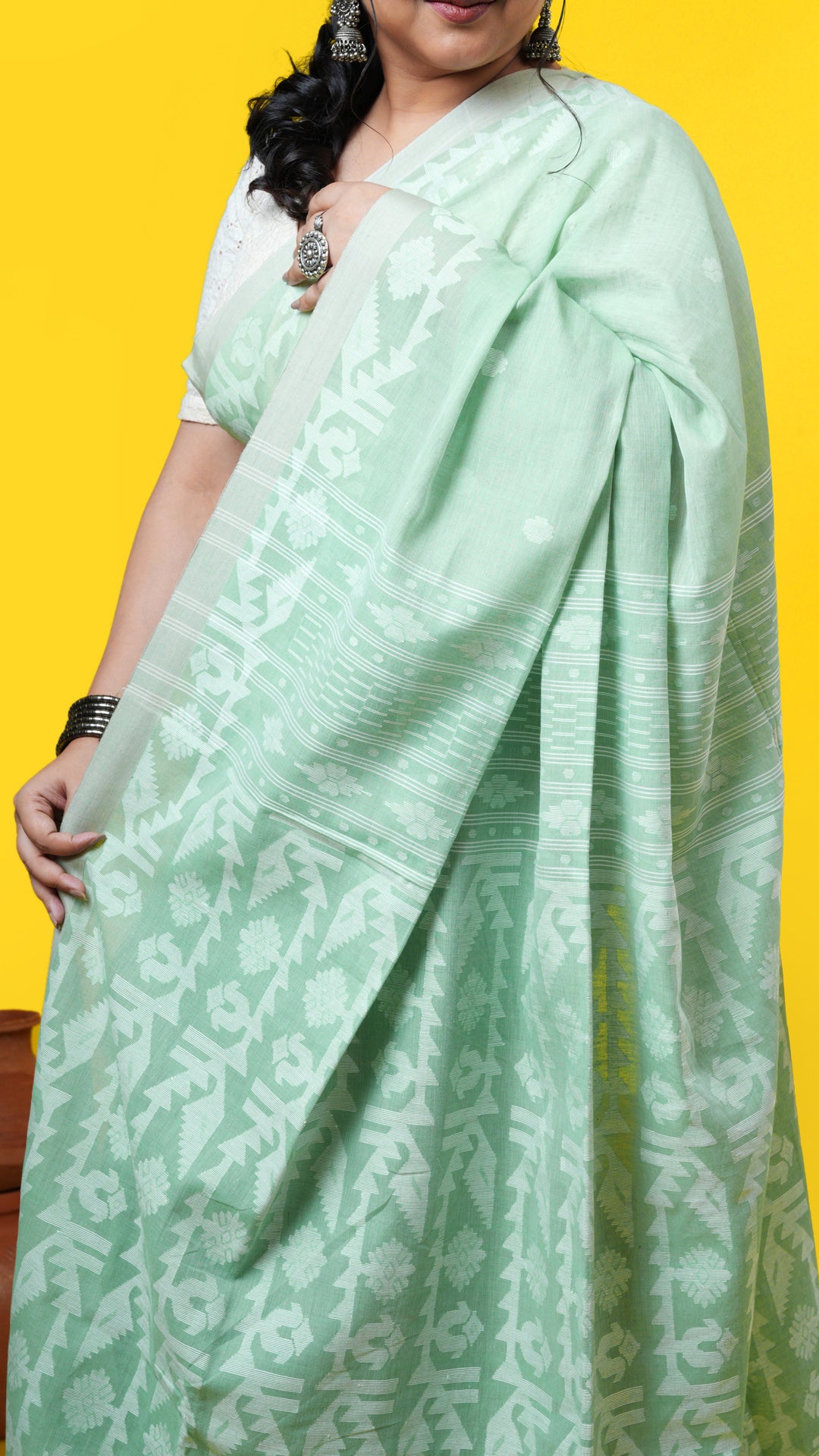 A light green coloured dhakai saree