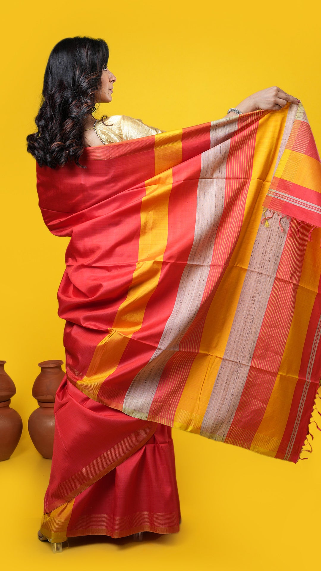 A vermillion coloured silk tangail saree
