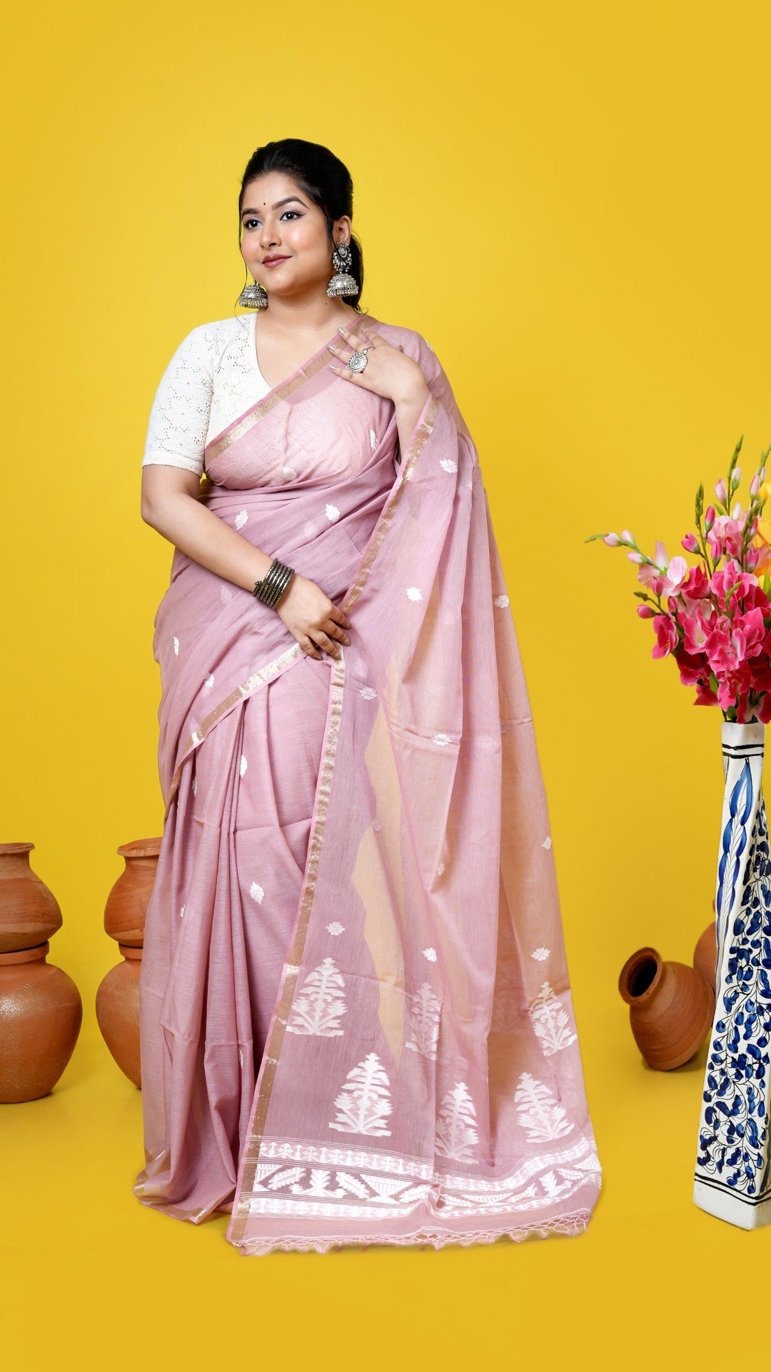 A cinnamon coloured tangail saree