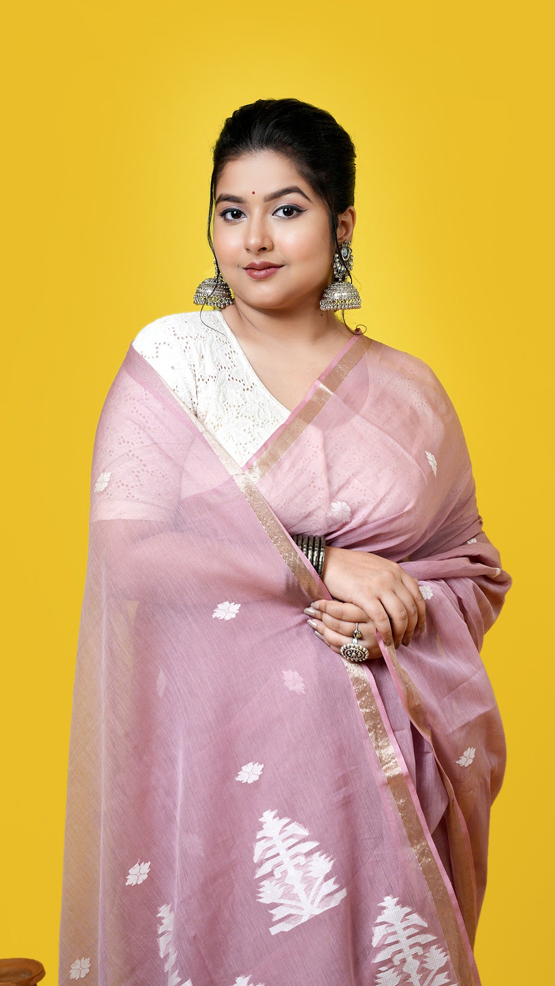 A cinnamon coloured tangail saree