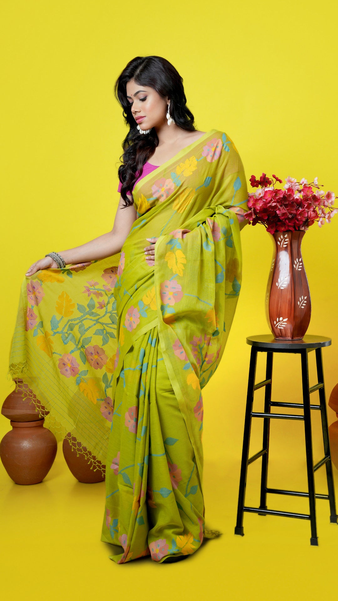 Bright green soft cotton Dhakai saree with multicolor floral weave in yellow, blue, pink, orange, and red. Price: Rs. 18,000/-