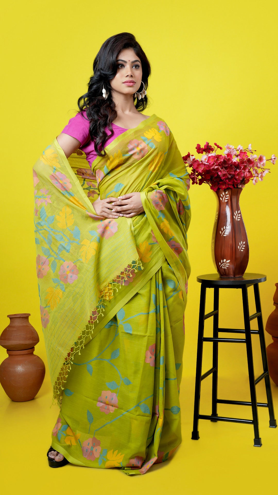 A bright green coloured dhakai saree