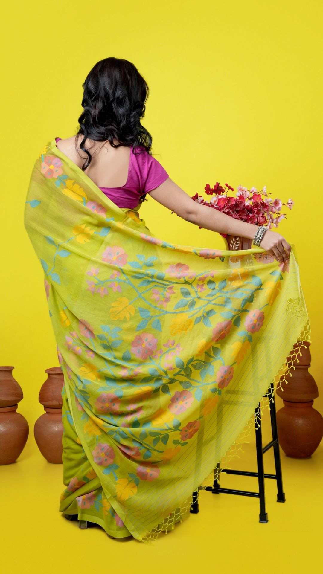 A bright green coloured dhakai saree