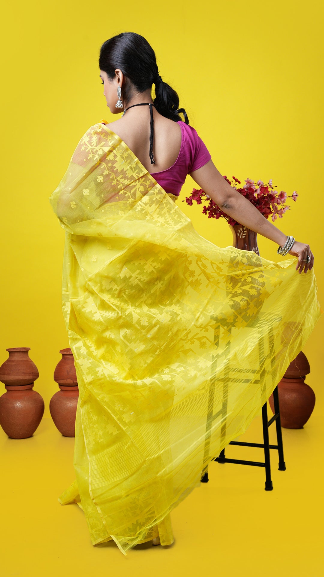 A yellow coloured jamdani saree