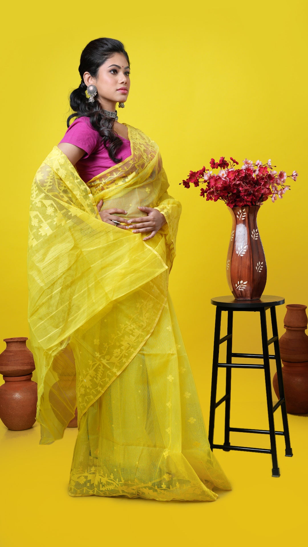 A yellow coloured jamdani saree