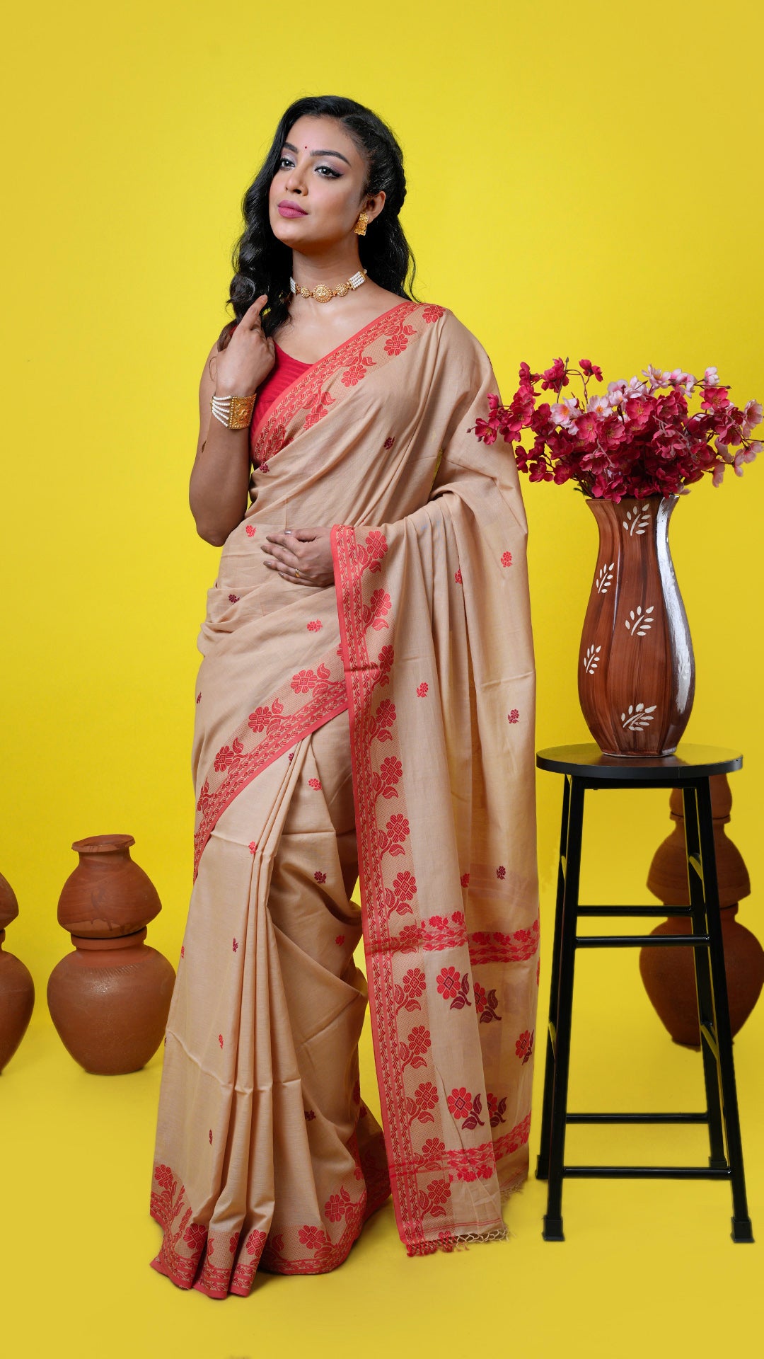 Beige soft cotton Tangail saree with red woven border, red and maroon butis and pallu. Price: Rs. 3000/-