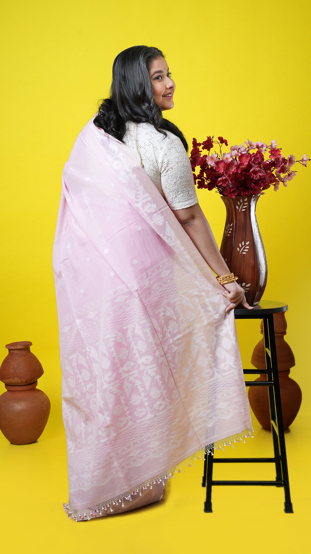A baby pink dhakai saree