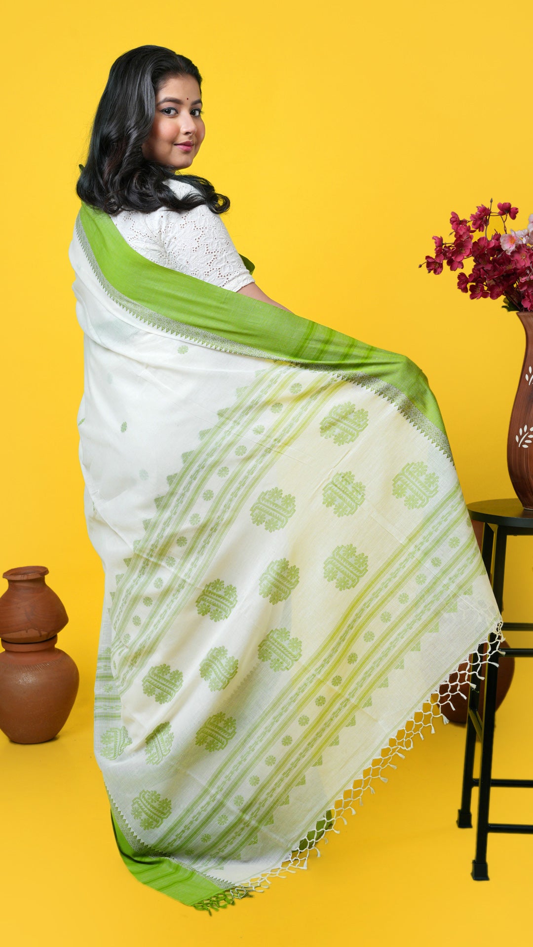 An off white and green tangail saree