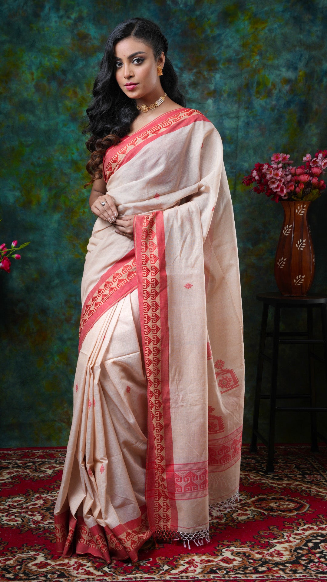 Beige soft cotton Tangail saree with red woven border, butis, and pallu. Price: Rs. 3000/-