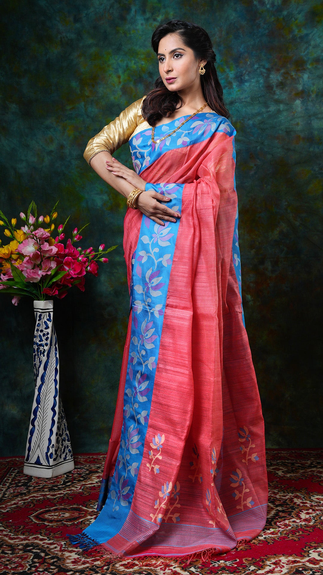 A peach coloured raw silk saree