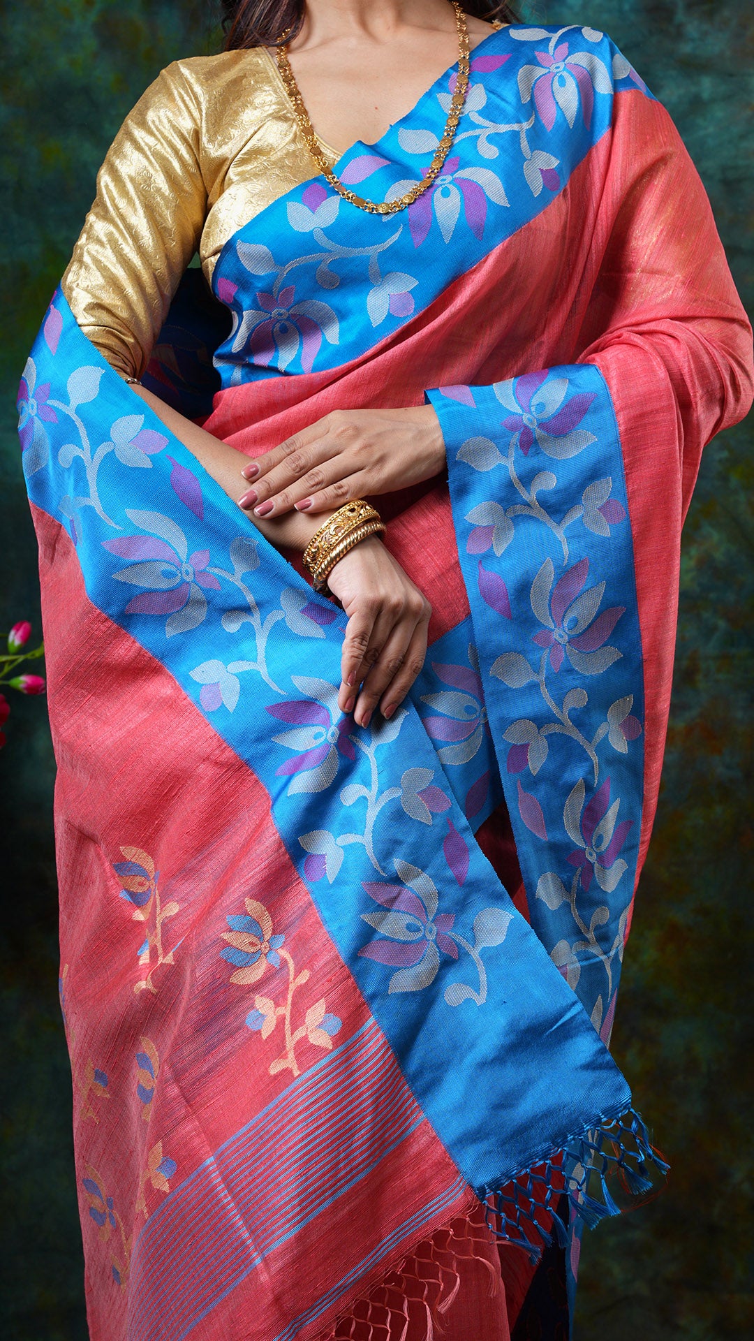 A peach coloured raw silk saree