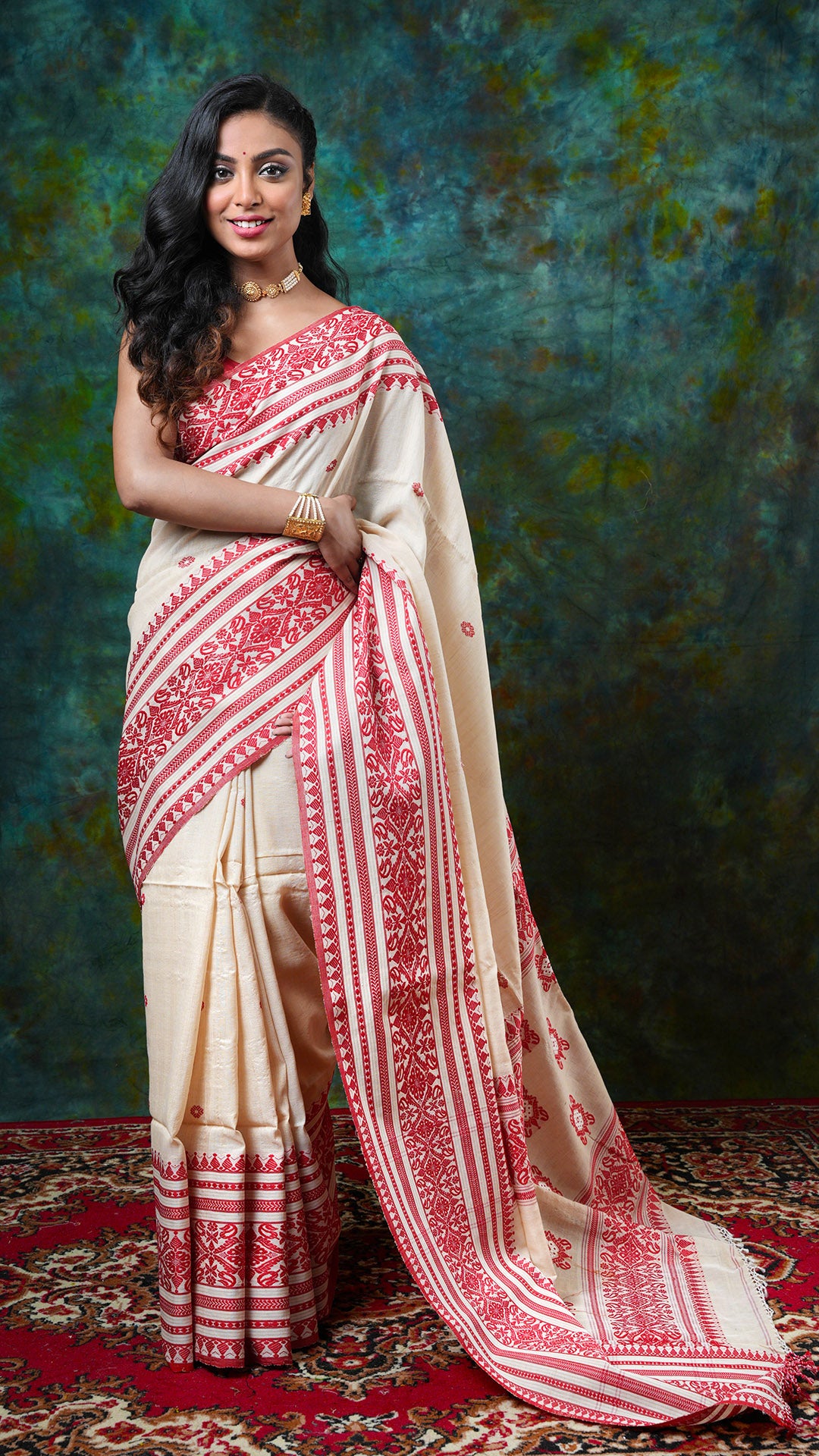 Natural Tassar-cotton Tangail saree with red woven border, butis, and pallu. Price: Rs. 9500/-