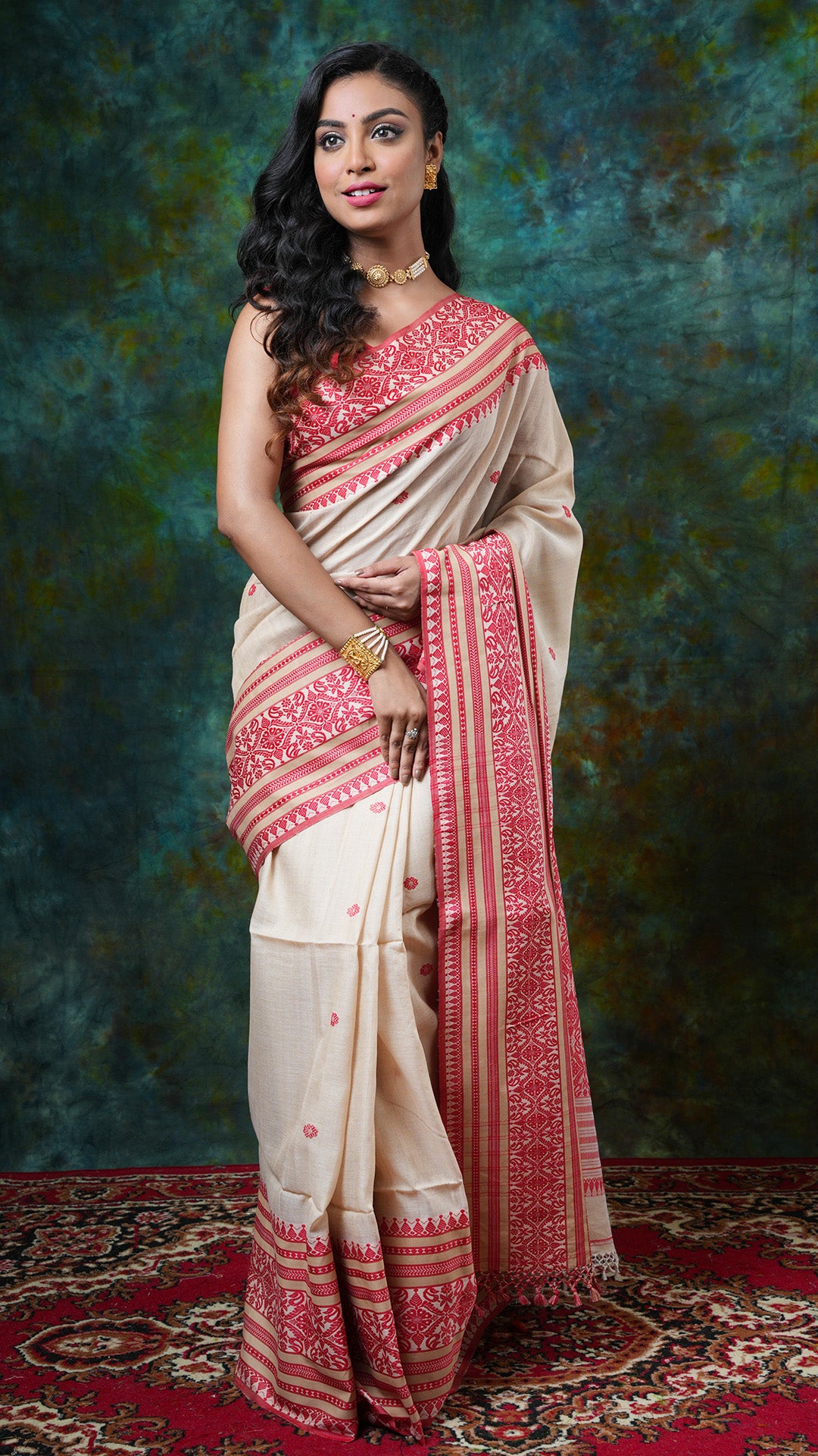 Natural Tassar Tangail saree with red woven border, butis, and pallu. Price: Rs. 11000/-